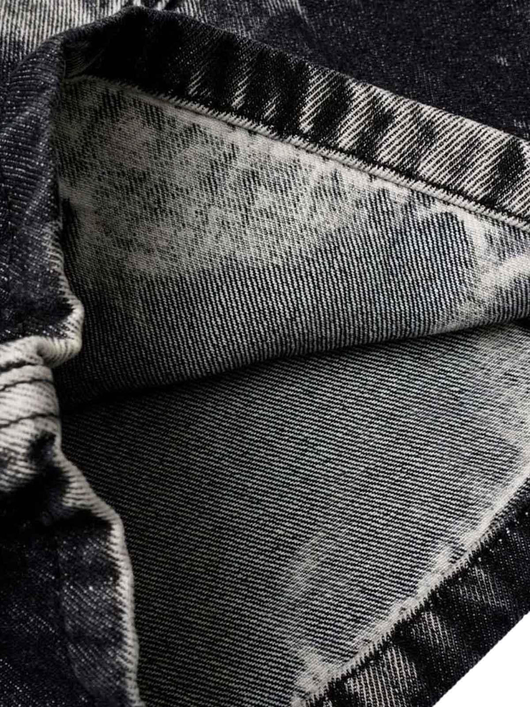 Intricate look at TALISHKO tie-dye cargo jorts, showcasing textured fabric and stitching.