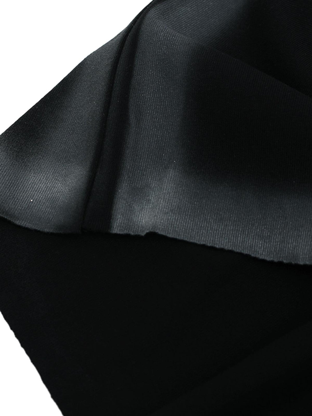 Intricate look at TALISHKO's black fabric texture, showcasing seamless stitching details.