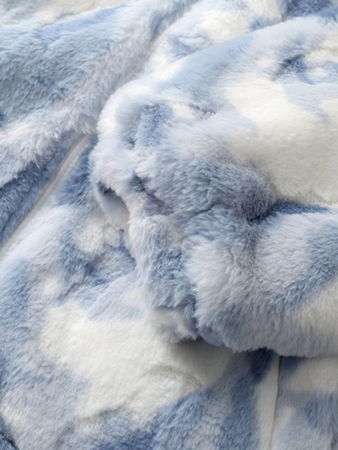 A close look at the soft, plush texture of TALISHKO's tie-dye sherpa coat.
