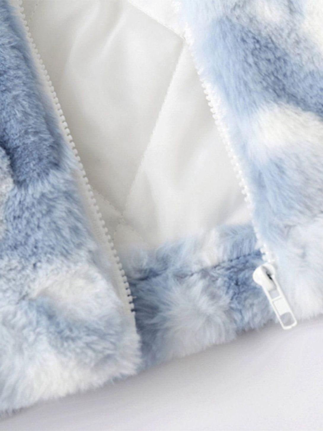 Focusing on the zipper and plush texture of TALISHKO's tie-dye sherpa coat.