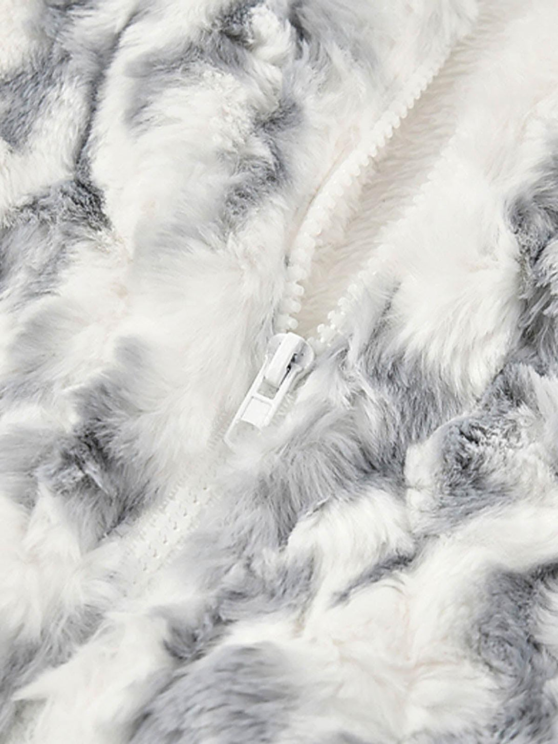 A close-up of the tie-dye sherpa jacket texture by TALISHKO, highlighting its soft, fluffy fabric.