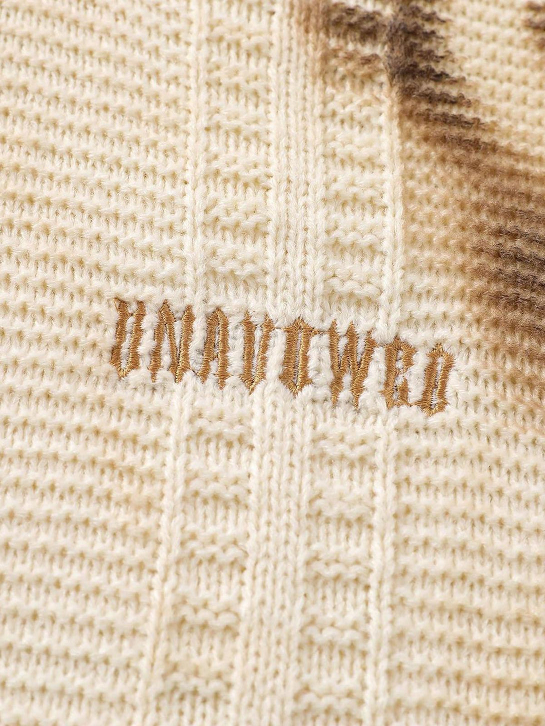 Intricate look at TALISHKO's tie-dye sweater, focusing on the textured knit and unique design.