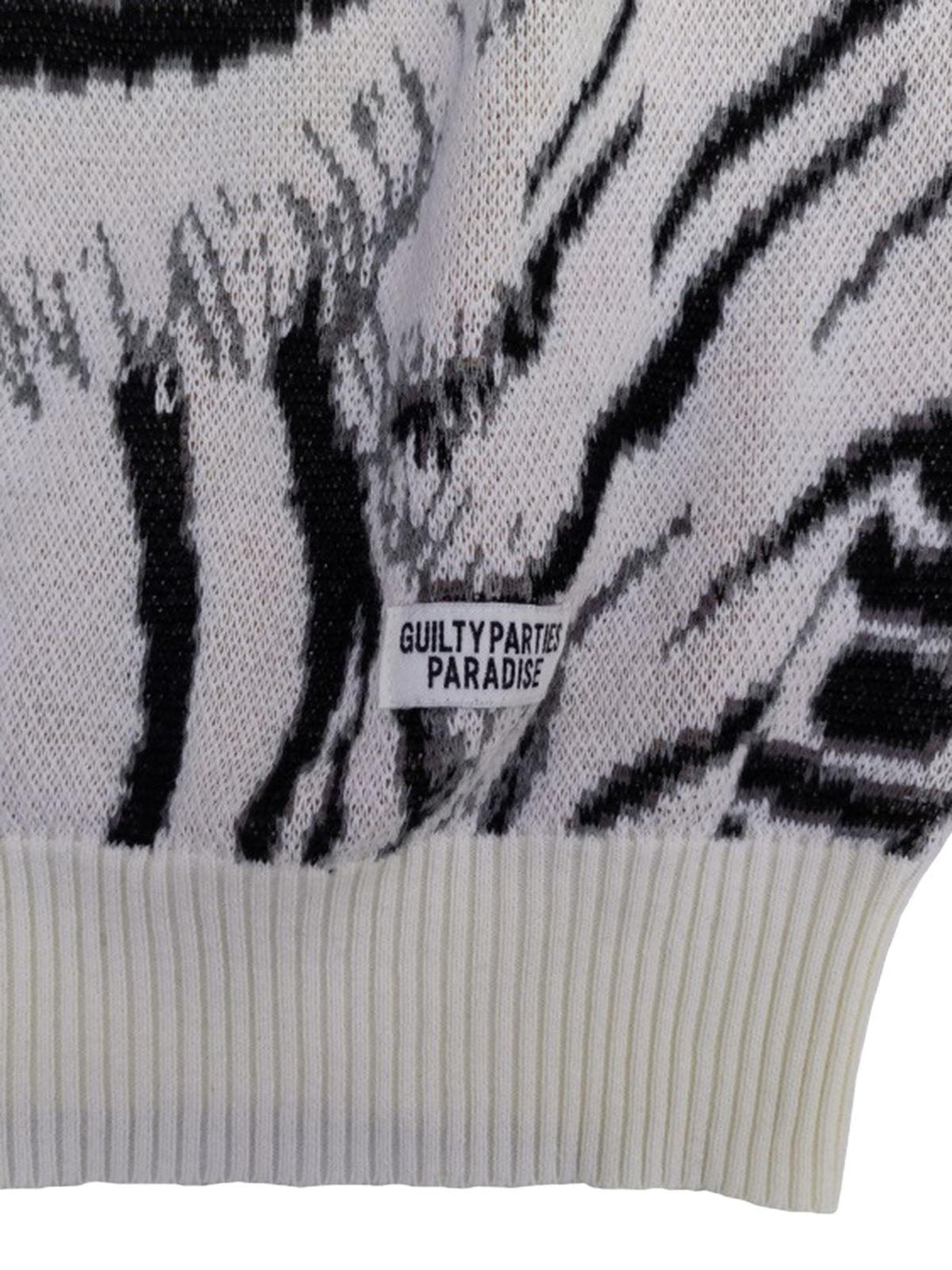 Intricate look at TALISHKO's tiger-patterned sweater label, highlighting unique knit design.