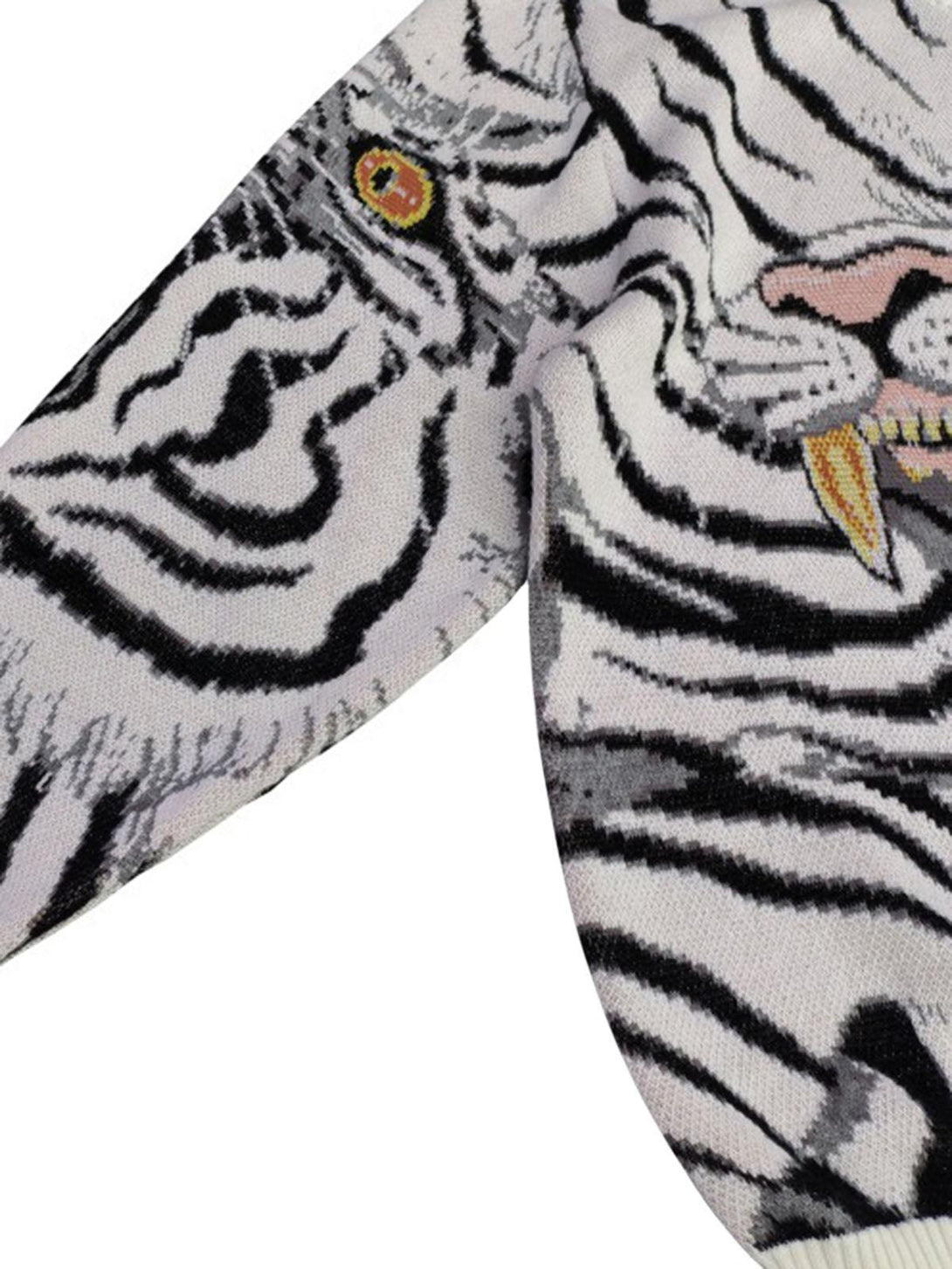 Intricate tiger motif on TALISHKO's crew neck sweater sleeve, showcasing bold knit details.