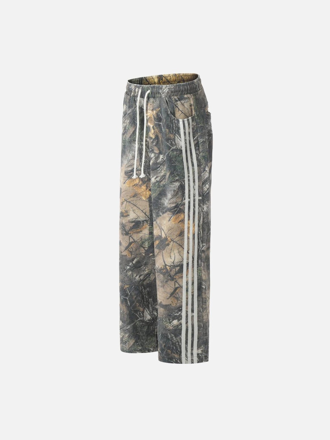 Side view of TALISHKO drapey pants with tree branch digital print and stripe details.