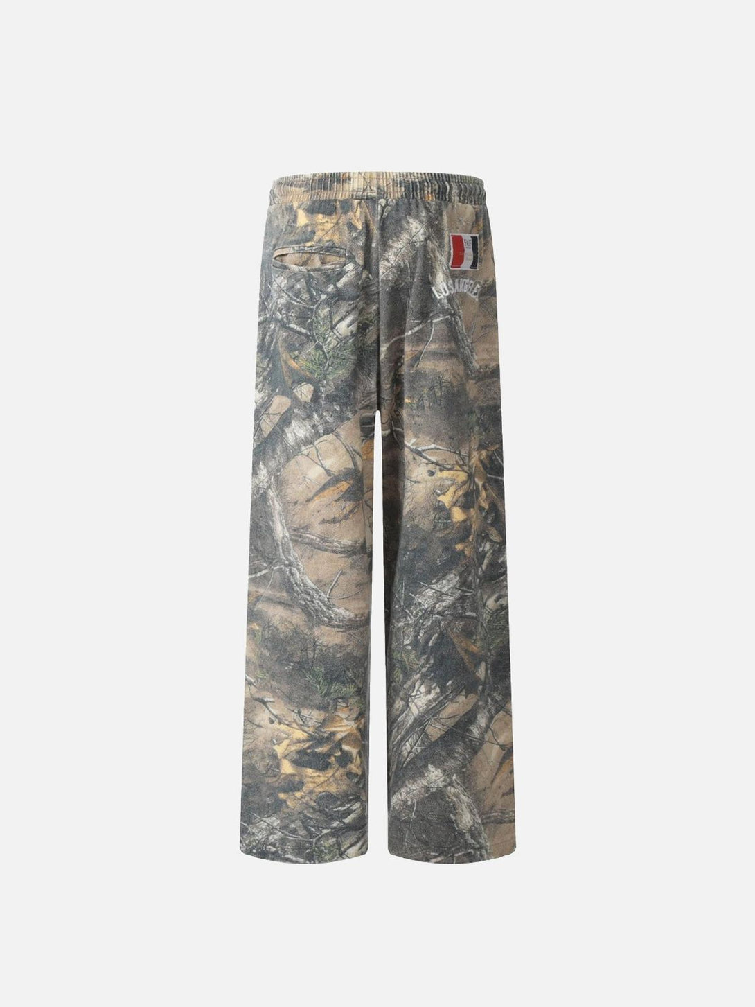 Back view of TALISHKO drapey pants showcasing a tree branch digital print with earthy hues.