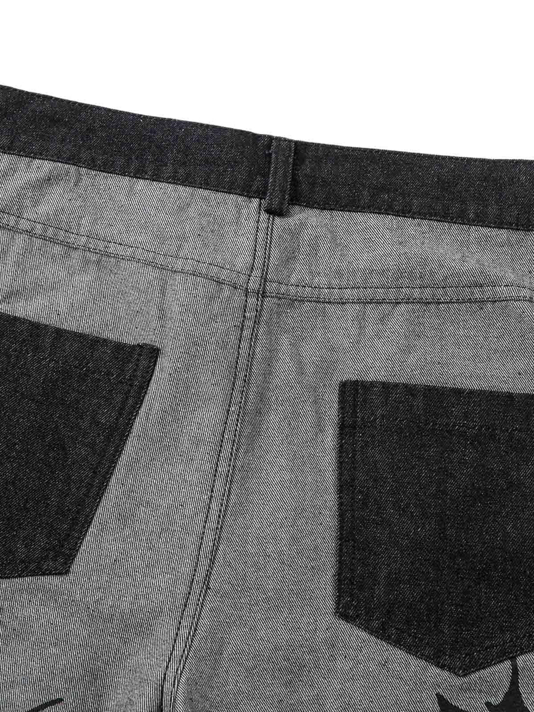 Back detail of TALISHKO baggy jeans, featuring bold tribal flame print and contrasting pockets.
