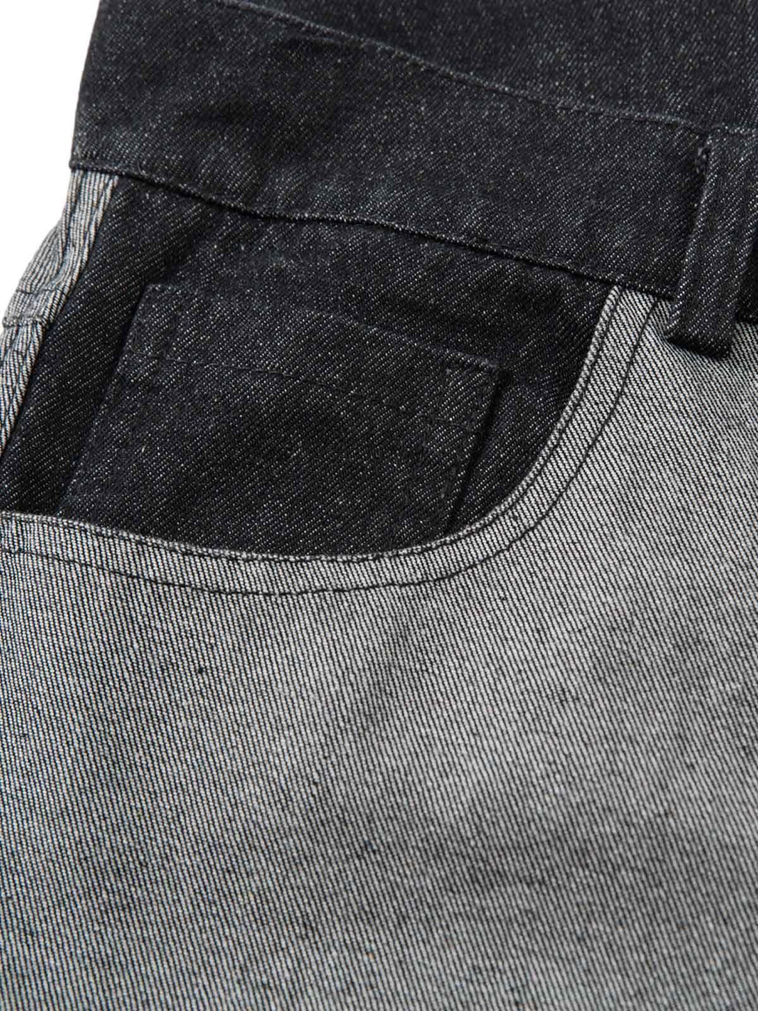 Zoomed-in texture of TALISHKO baggy jeans, showcasing unique tribal flame pattern.