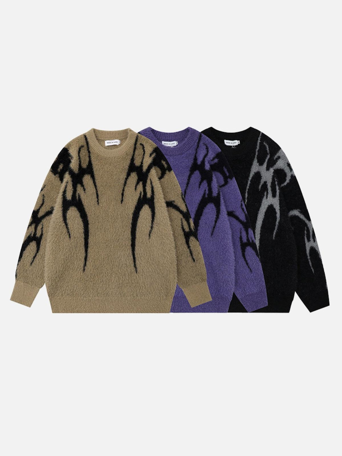 Trio of TALISHKO tribal jacquard knit sweaters in khaki, purple, and black, showcasing bold patterns.