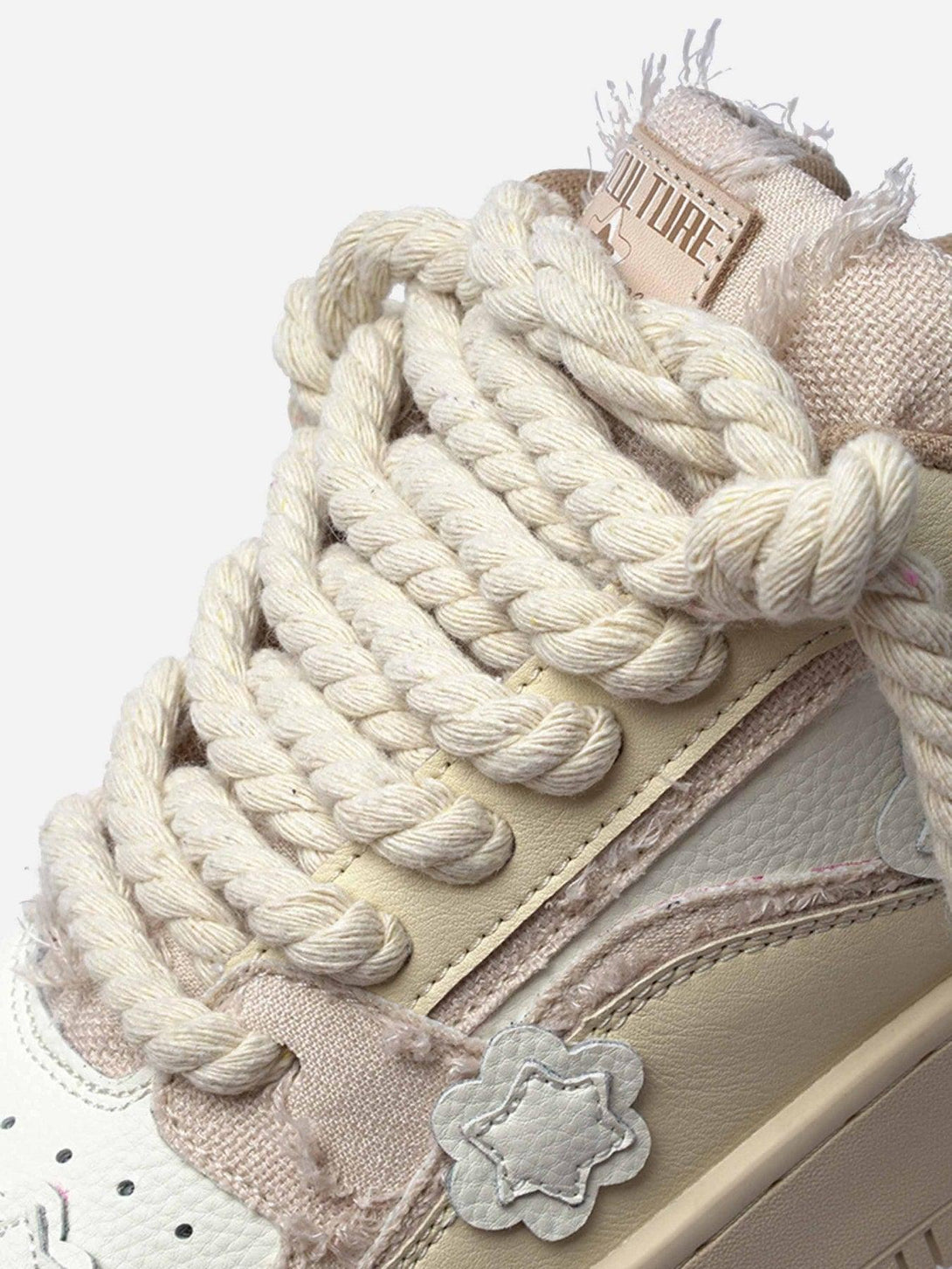 Intricate look at TALISHKO board shoes with chunky twine laces and star accents.