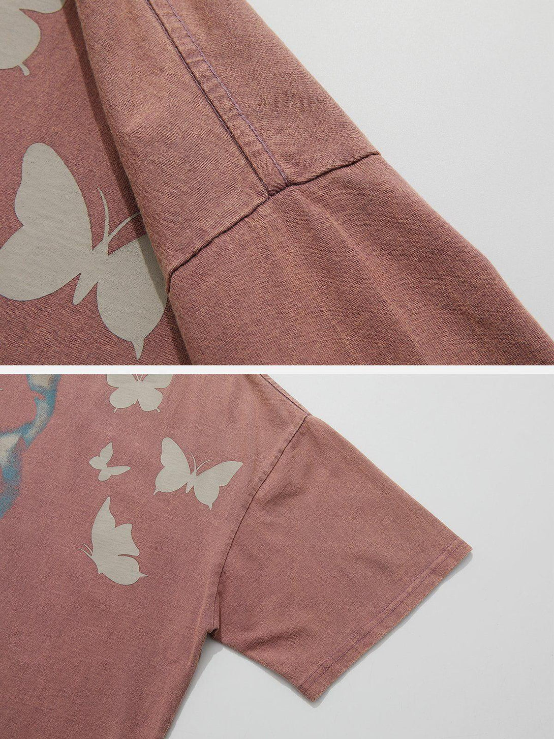 Intricate look at a TALISHKO tee sleeve, featuring butterfly patterns and detailed stitching.