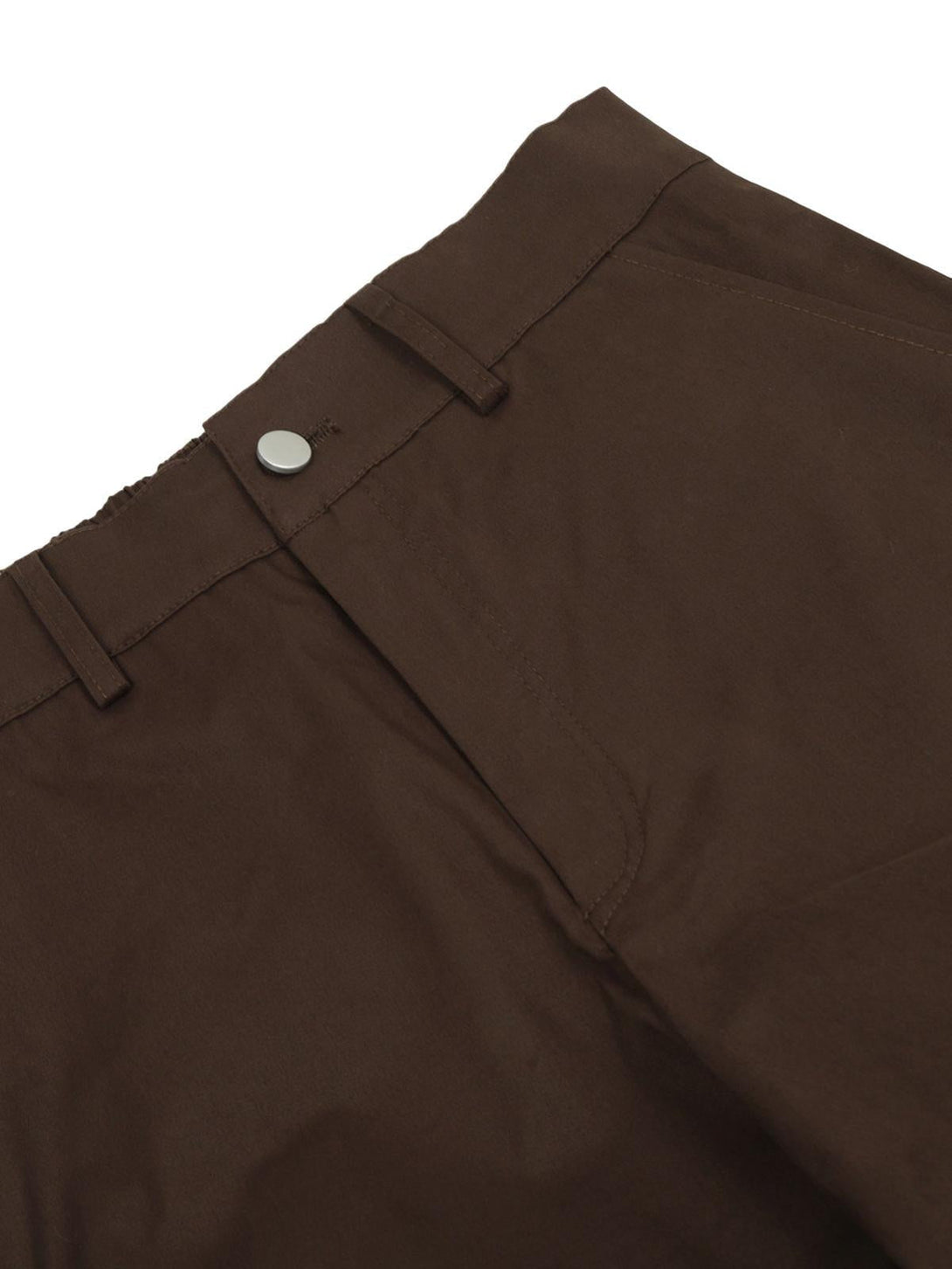 A close-up of TALISHKO Urban Explorer cargo pants in brown, highlighting the snap closure detail.