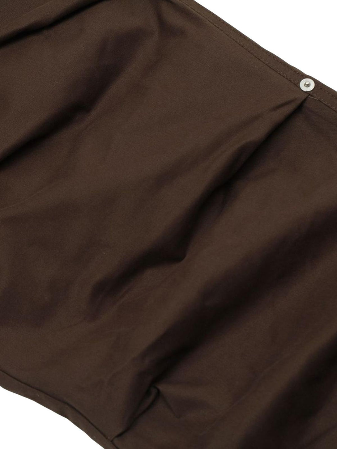Focusing on the rich brown fabric of TALISHKO Urban Explorer cargo pants with snap detail.