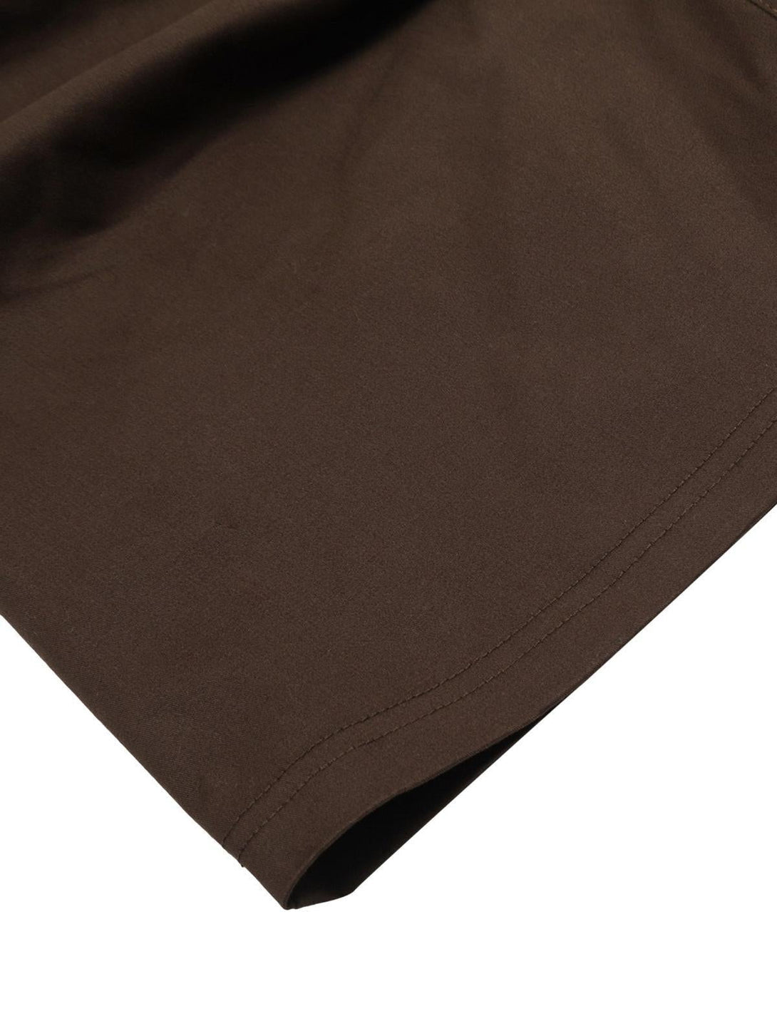 A detailed view of the brown TALISHKO Urban Explorer pants fabric and stitching.