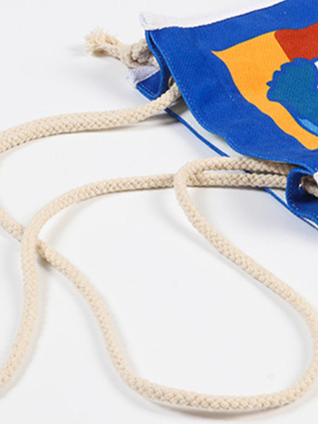 A tight crop highlighting the rope straps of TALISHKO's crossbody bag with a colorful design.
