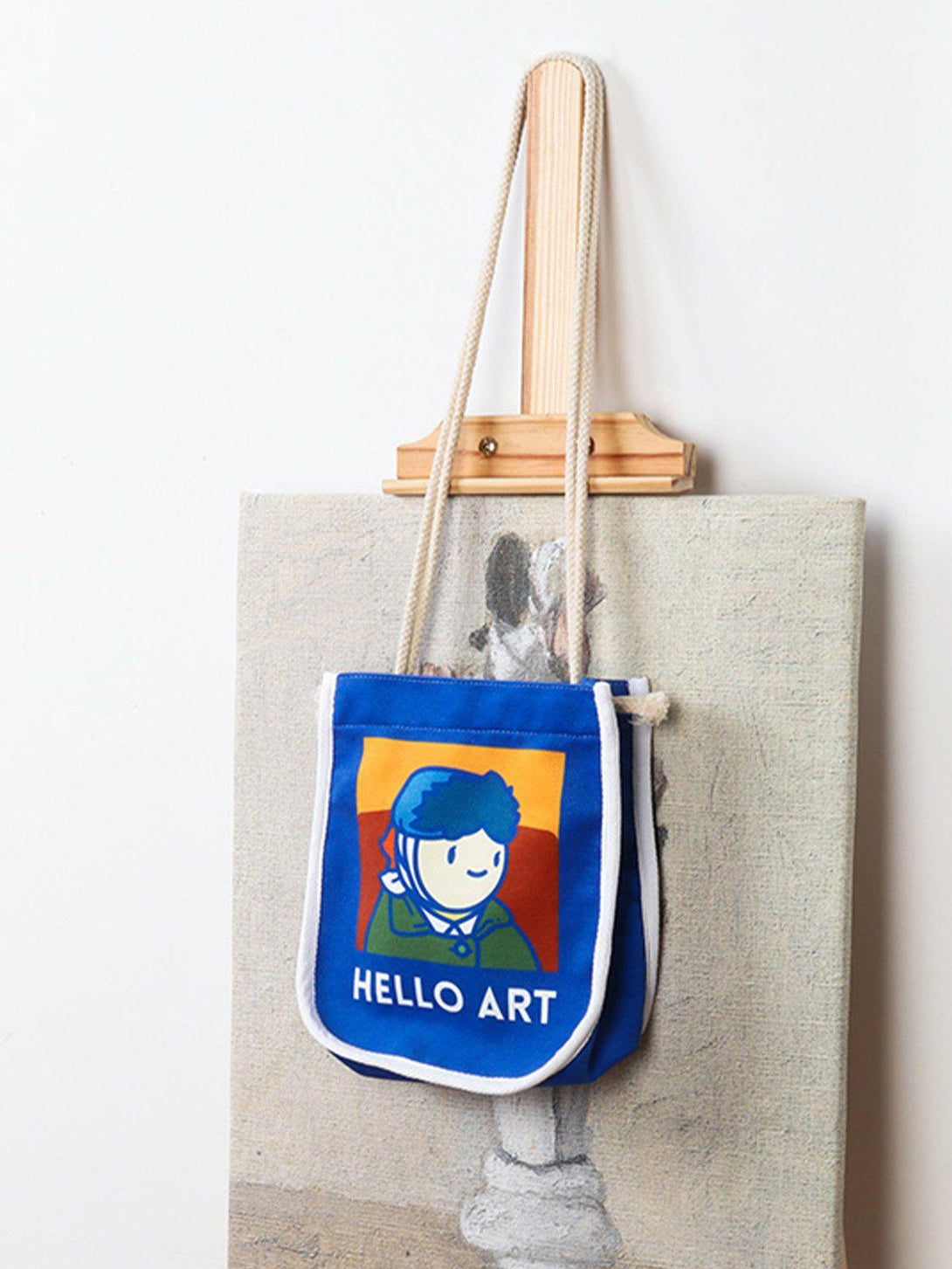 A charming crossbody bag by TALISHKO, showcasing a playful Van Gogh cartoon design.