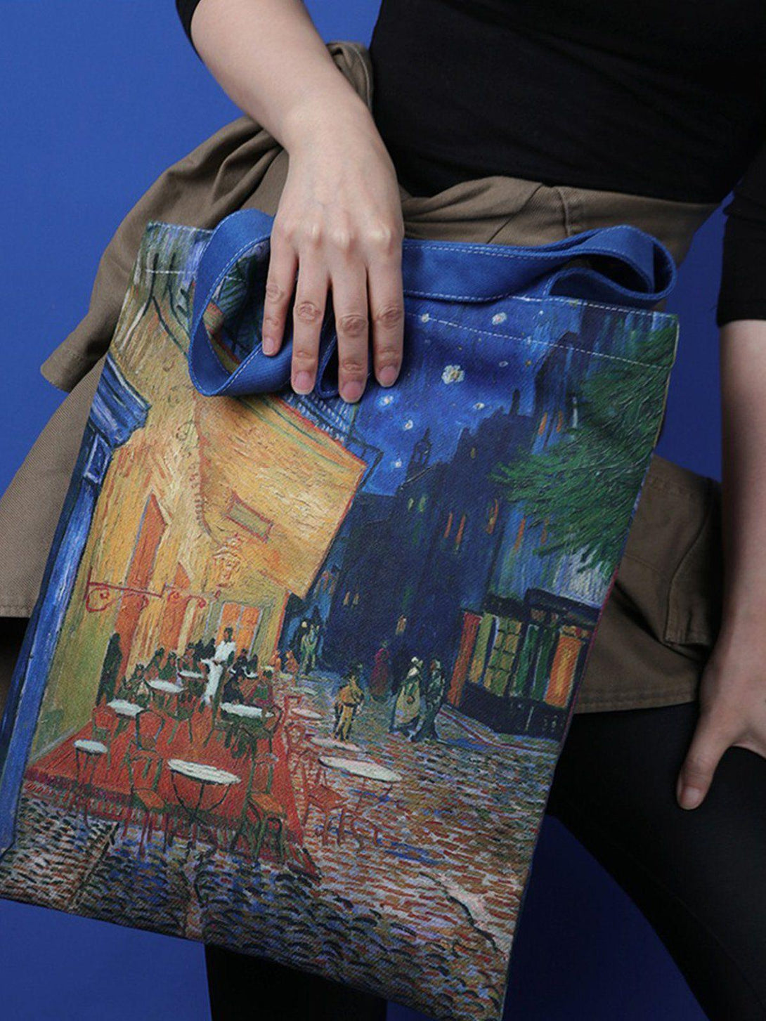 Model holding TALISHKO tote bag with Van Gogh artwork, ideal for a stylish, artistic look.