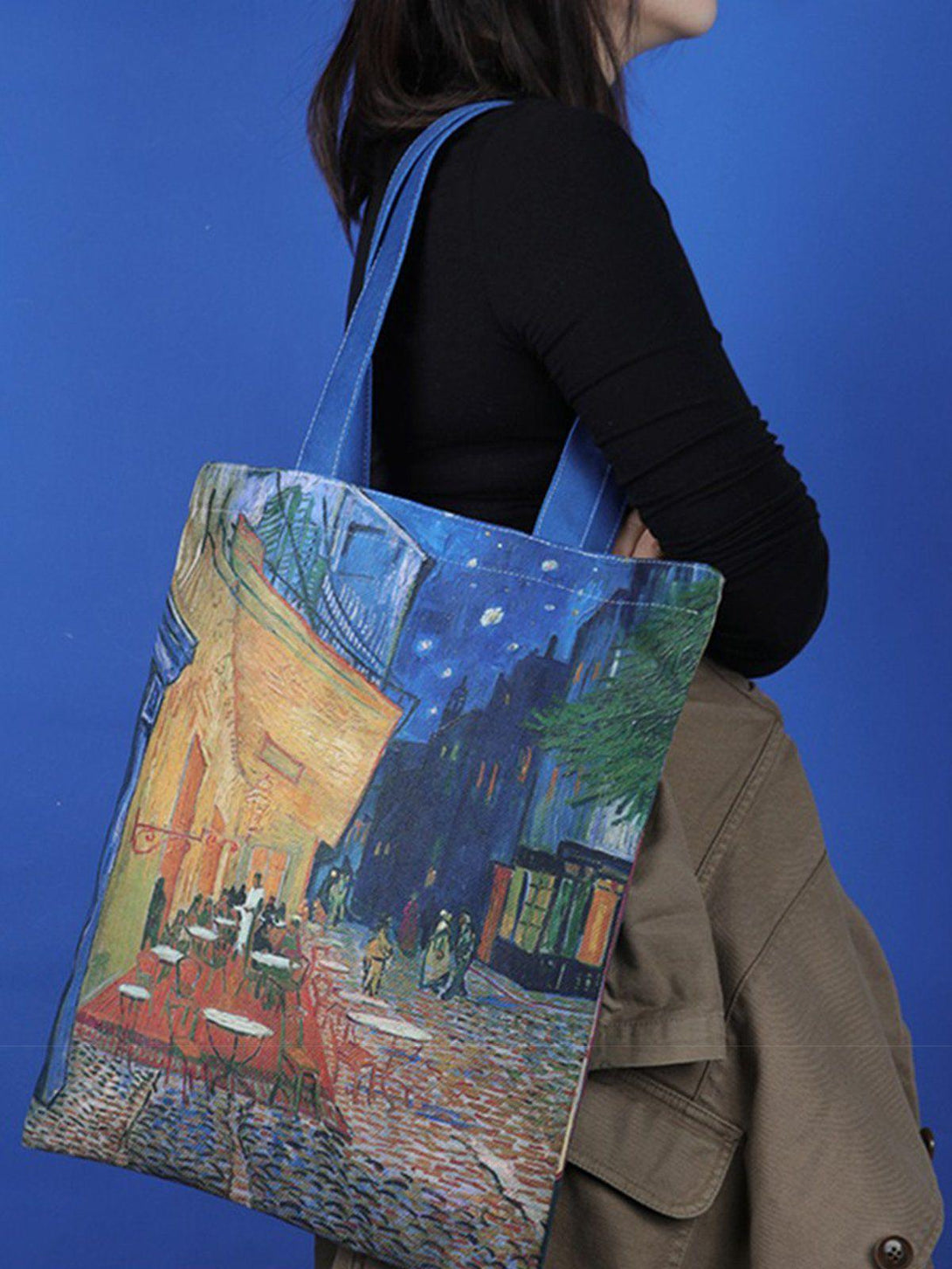 Model carrying TALISHKO canvas bag with a Van Gogh painting print, adding artistic flair.