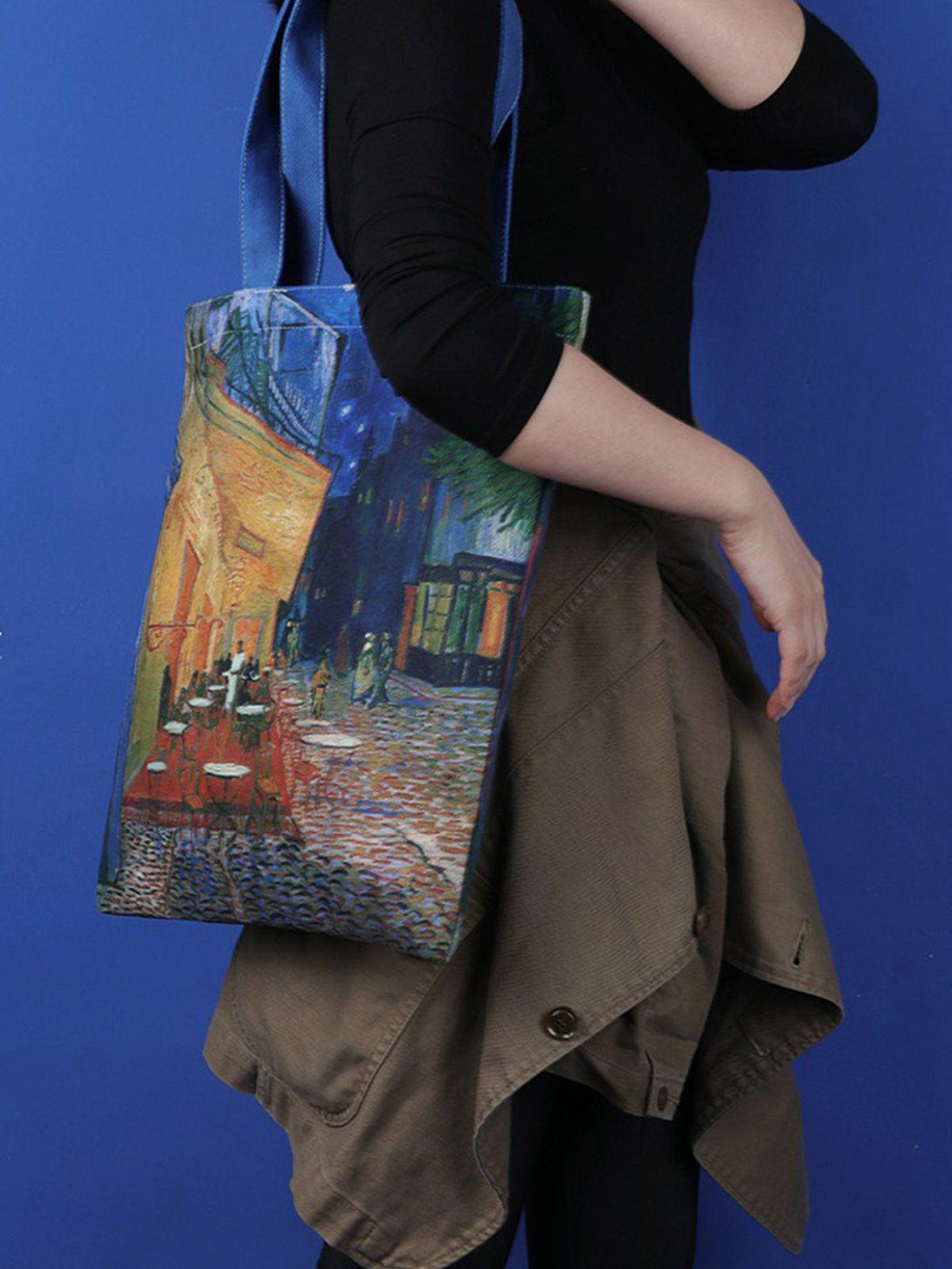 Model showcasing TALISHKO tote bag with vibrant Van Gogh painting, adding a touch of artistry.