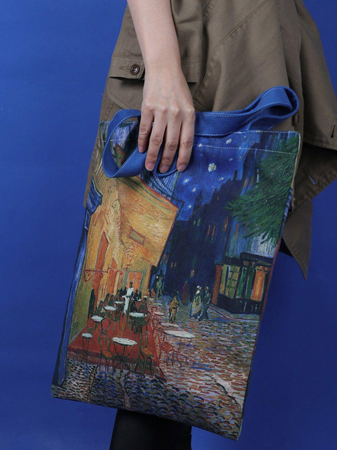 Model holding a TALISHKO canvas bag with Van Gogh artwork, adding a unique artistic touch.