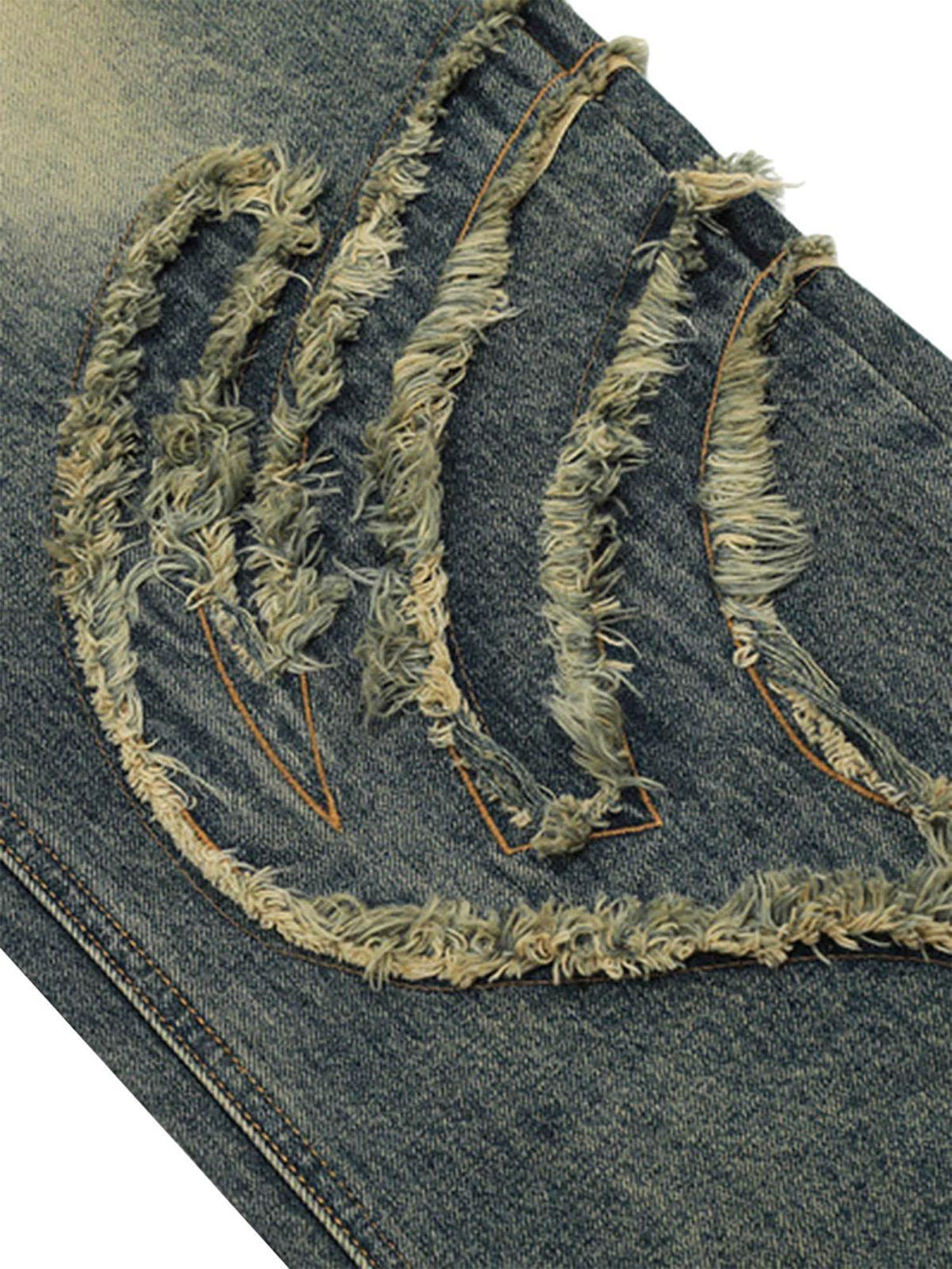 Intricate look at TALISHKO's vintage baggy jeans, showcasing unique distressed patterns.