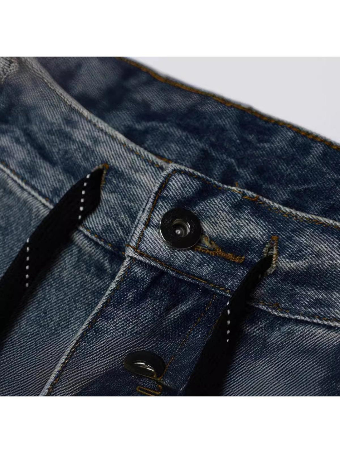 TALISHKO vintage cargo jeans button detail, showcasing quality craftsmanship and texture.