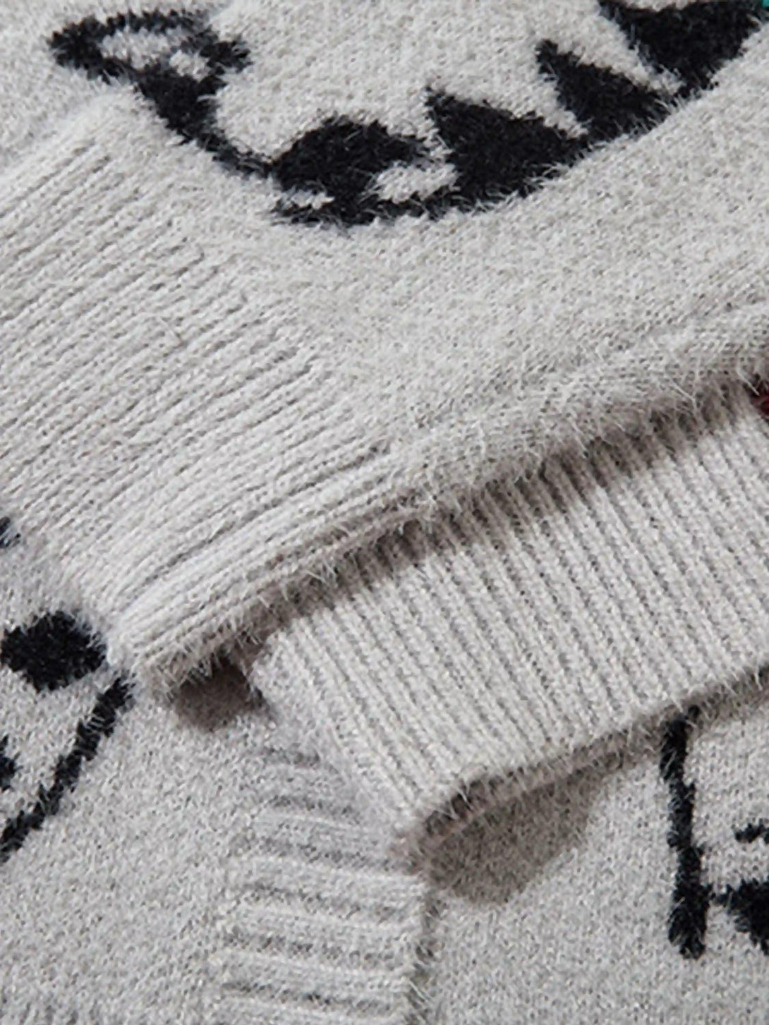 Texture and pattern showcased on TALISHKO's vintage knit cardigan with cat jacquard design.