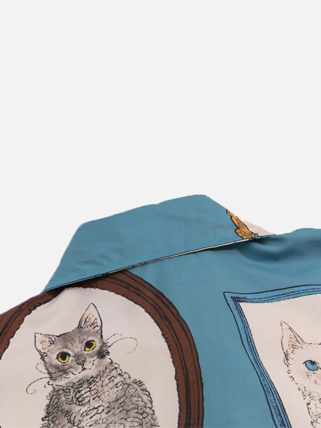 A close-up of the vintage cat print on TALISHKO's short sleeve shirt, emphasizing unique design.
