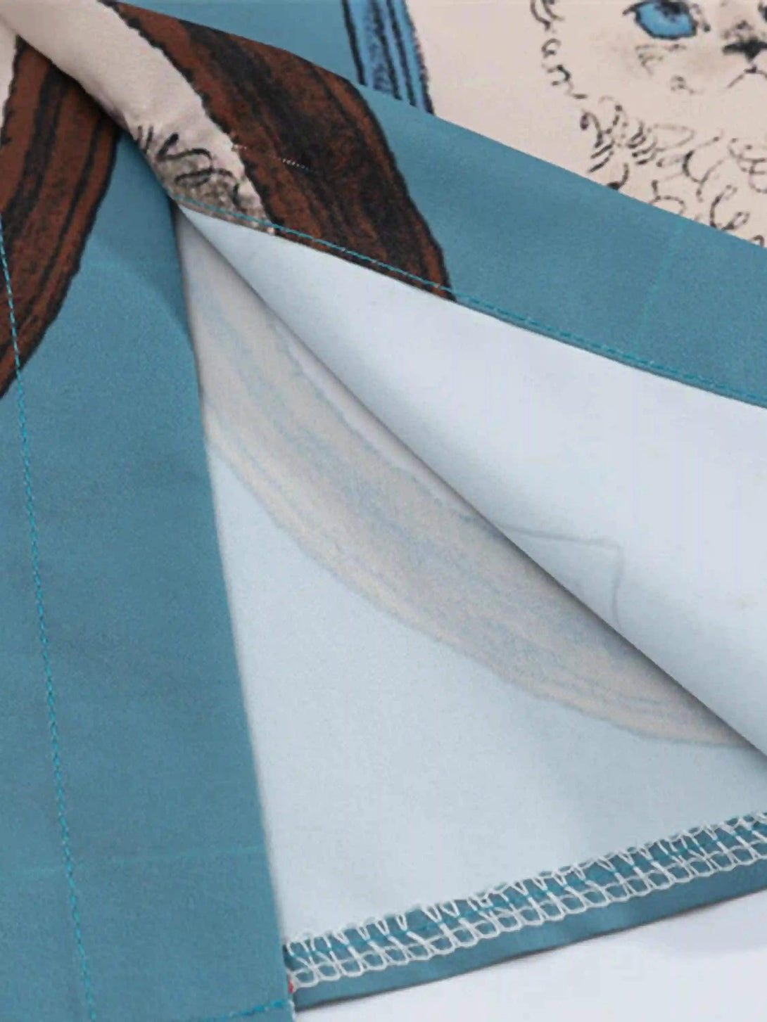 Detailed fabric and stitching of TALISHKO's vintage cat print shirt, showcasing playful design.