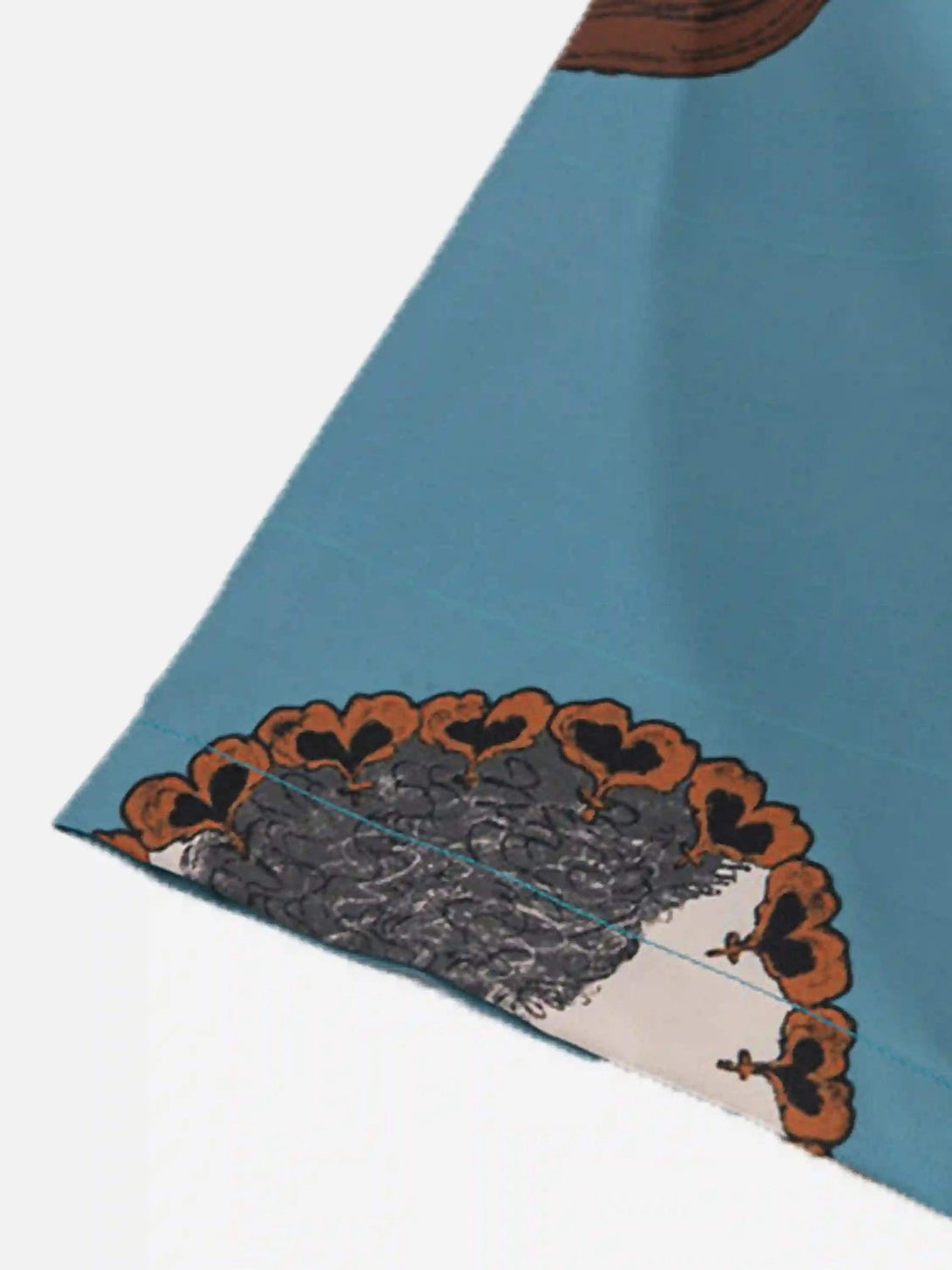 A detailed view of TALISHKO's vintage cat print shirt, highlighting intricate pattern accents.