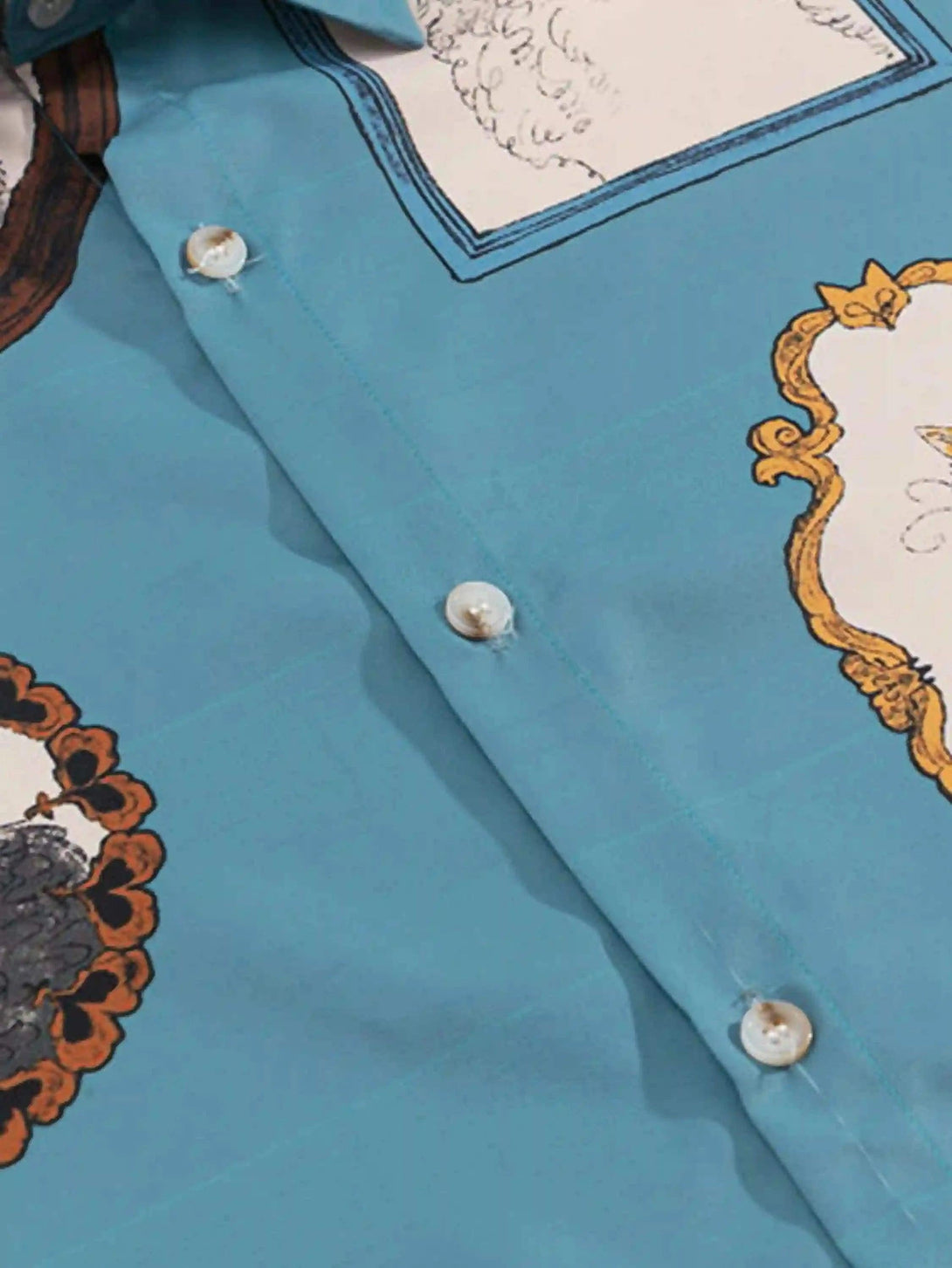 A detailed look at TALISHKO's vintage cat print shirt, highlighting button and pattern accents.