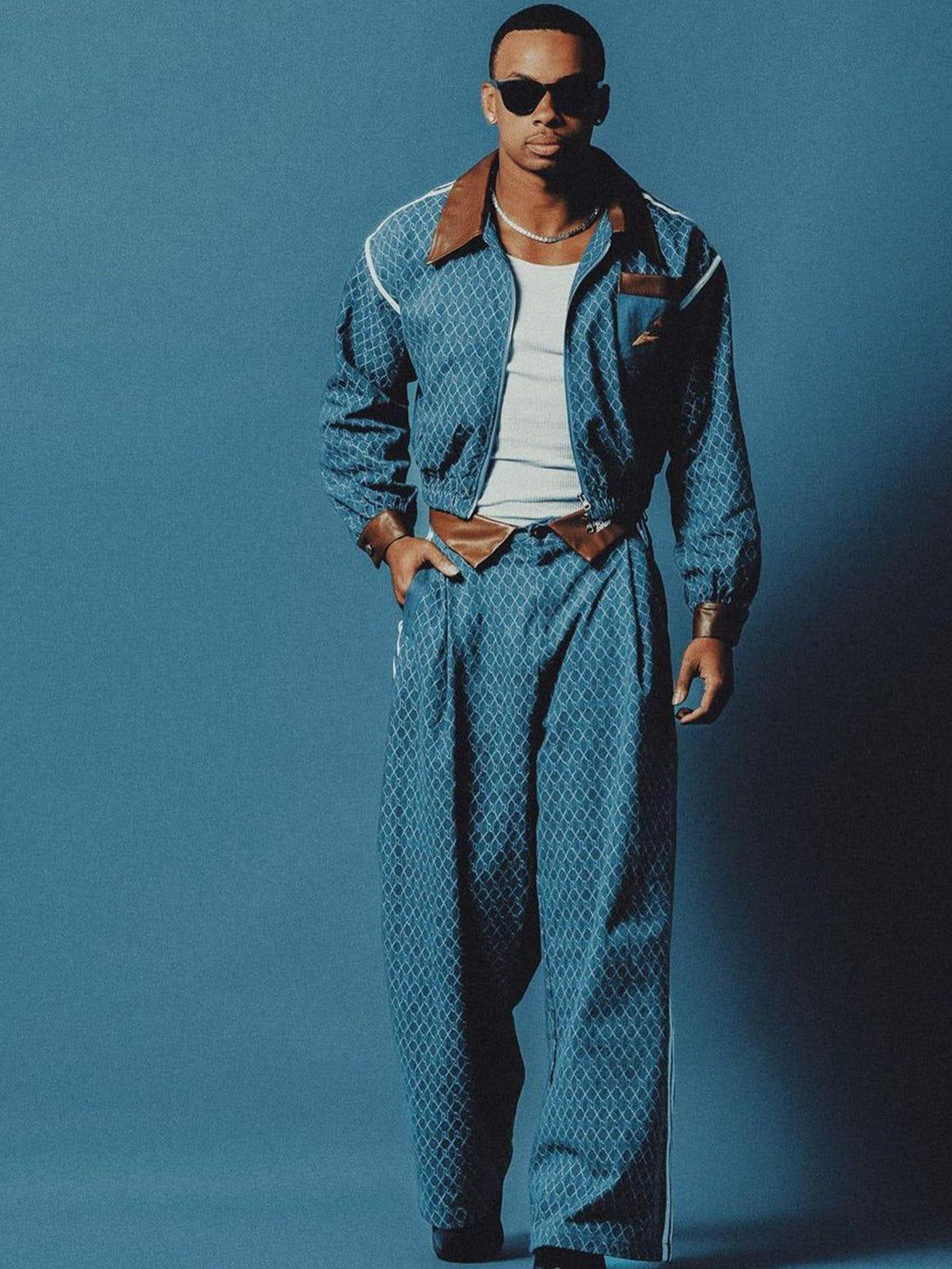 Model in stylish TALISHKO denim jacquard baggy jeans and jacket ensemble, exuding a vintage vibe.