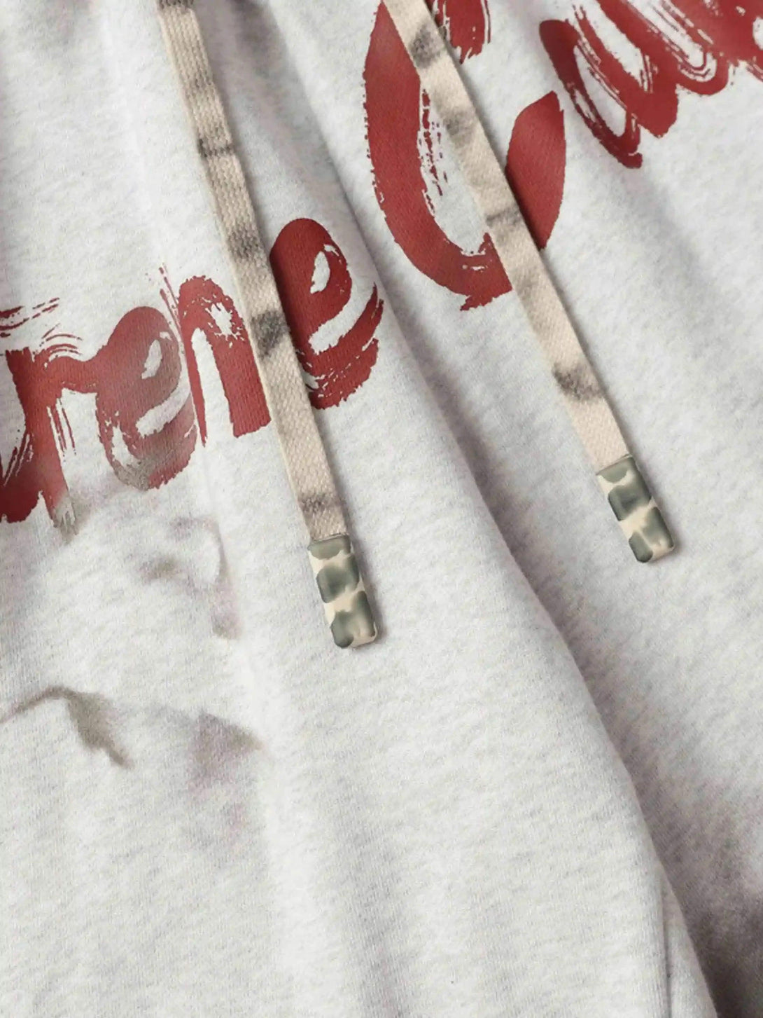 A detailed look at TALISHKO's vintage-style hoodie with elastic drawstring and bold lettering.