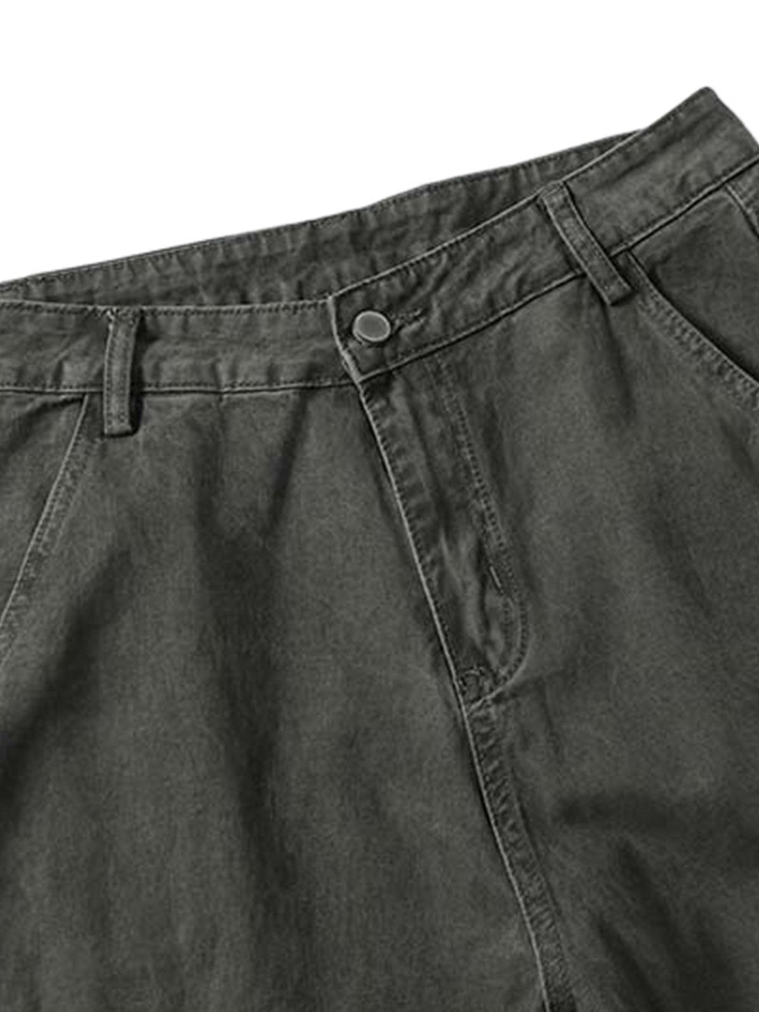 Focusing on the waist detail of TALISHKO vintage distressed cargo pants, showcasing button closure.