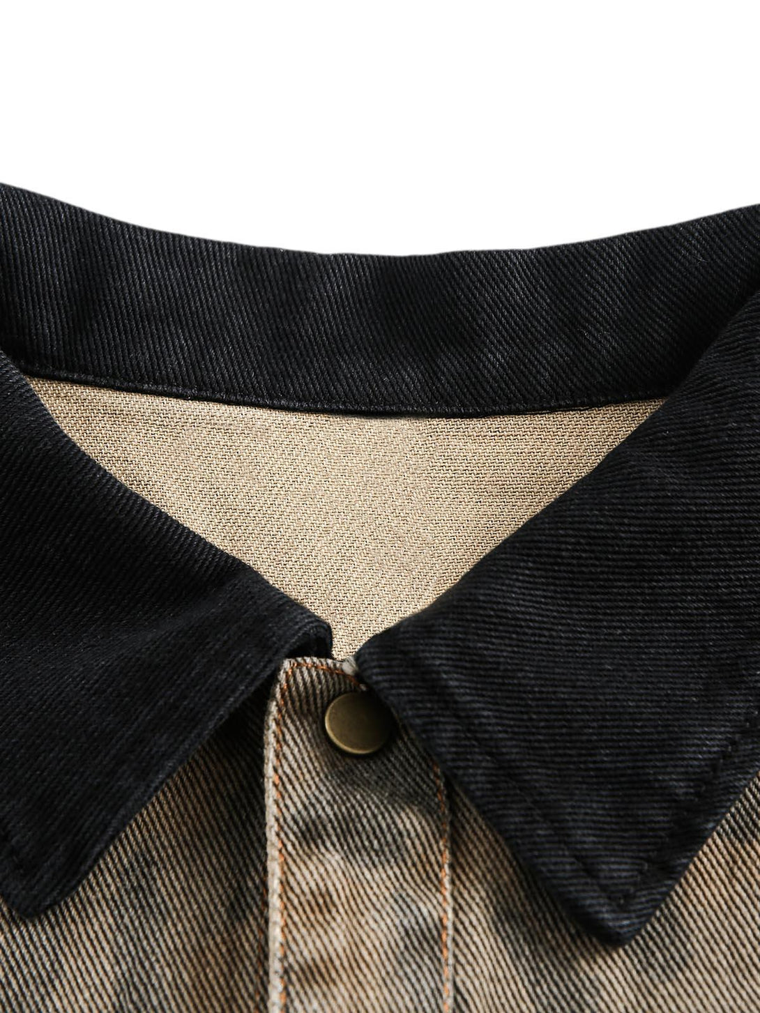 A close-up of TALISHKO's distressed cheetah print denim shirt collar, highlighting its texture.