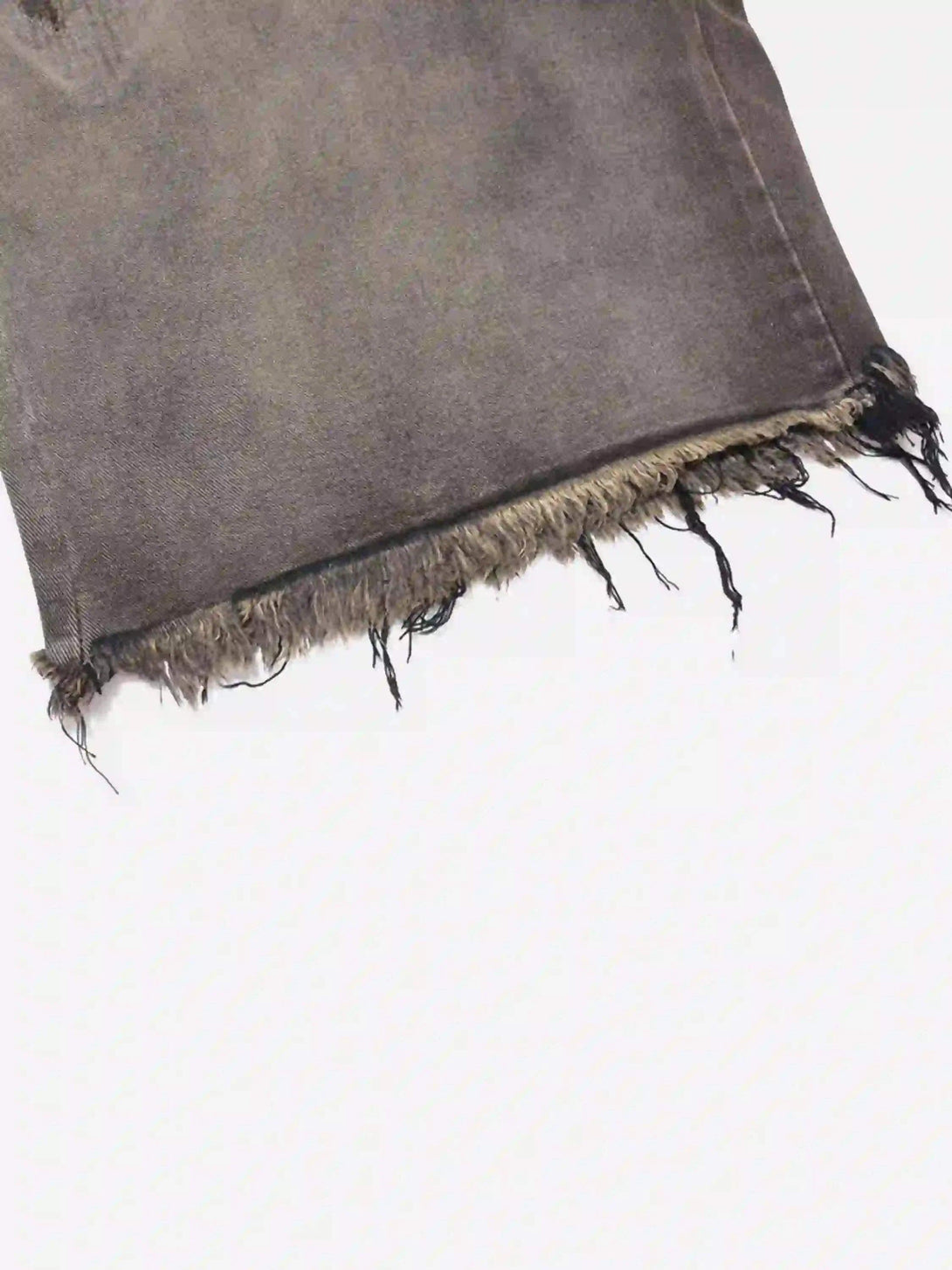 Frayed hem detail of TALISHKO's vintage distressed denim shorts, showcasing the gradient texture.