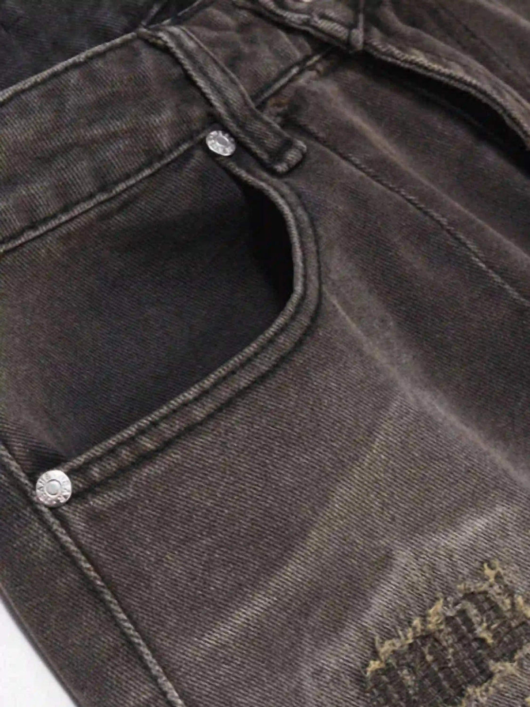 Intricate look at TALISHKO's vintage denim shorts, highlighting the pocket and distressed texture.