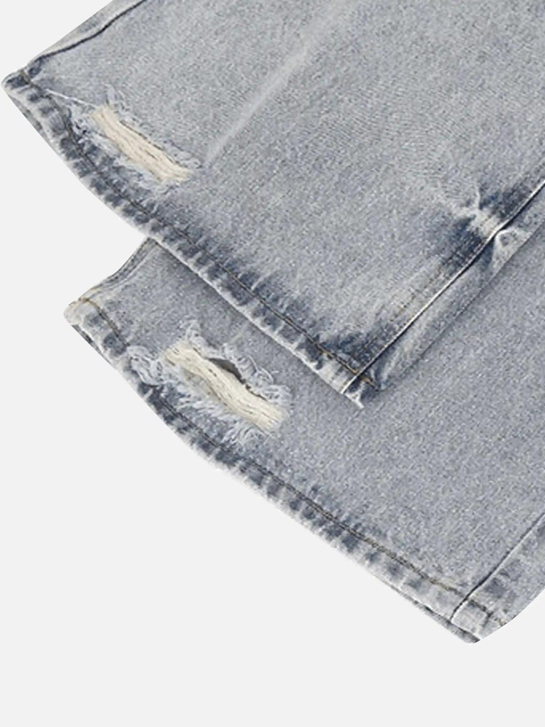 A detailed view of TALISHKO vintage distressed jeans, highlighting texture and unique style.