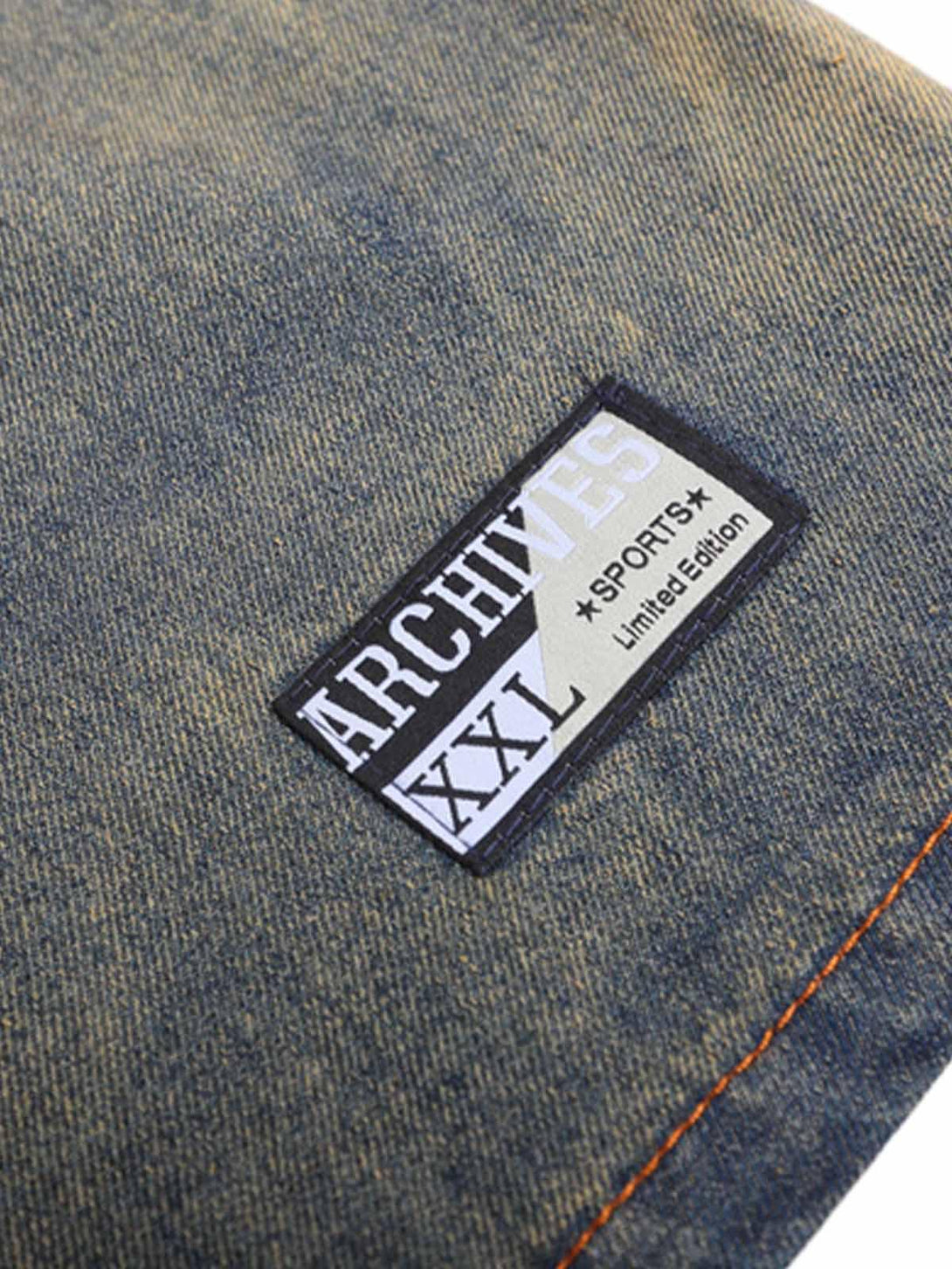 TALISHKO's vintage denim T-shirt features a detailed logo patch and textured fabric.