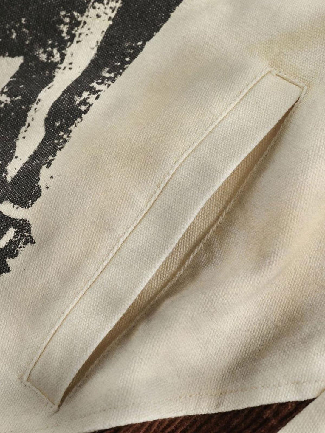 Detailed pocket view on TALISHKO's vintage Doberman graphic jacket, showcasing fabric texture.