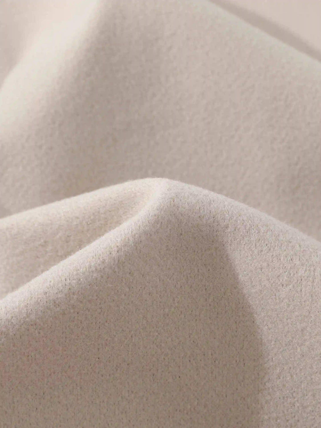 "Zoomed-in texture of a vintage embroidered baseball jacket by TALISHKO, highlighting fabric detail."