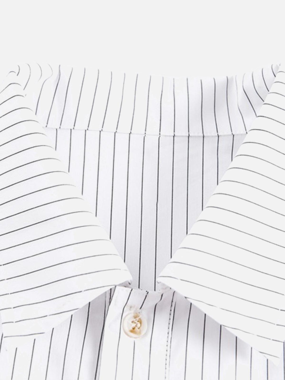Striped collar detail of a shirt by TALISHKO, highlighting sleek lines and button closure.