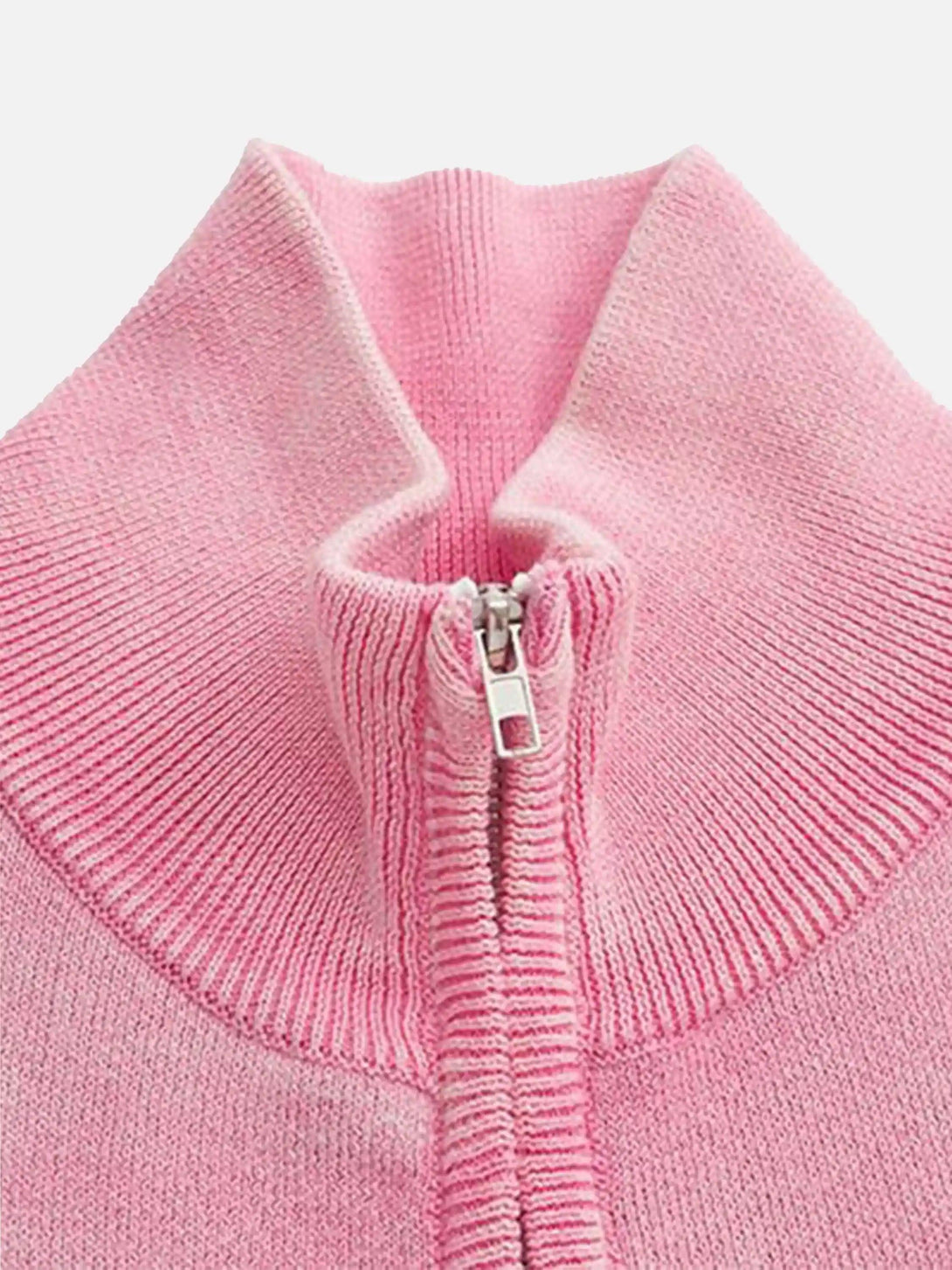 Zoomed-in view of a pink TALISHKO cardigan, showcasing the stand collar and zipper detail.