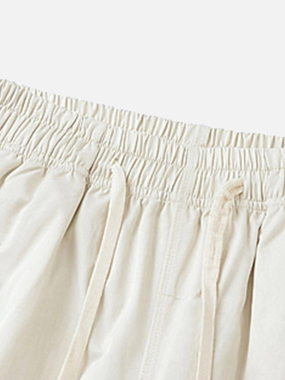 A close-up of TALISHKO vintage flame shorts, highlighting the elastic waistband and drawstring detail.