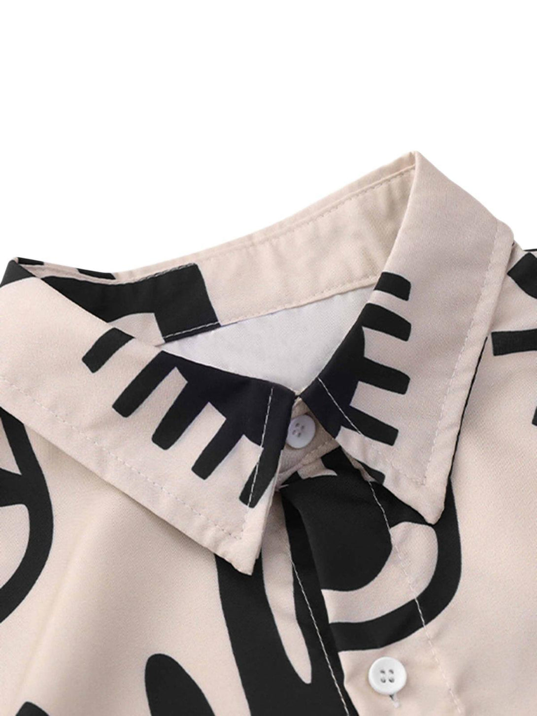 A detailed view of the collar and abstract print on a vintage short sleeve shirt by TALISHKO.