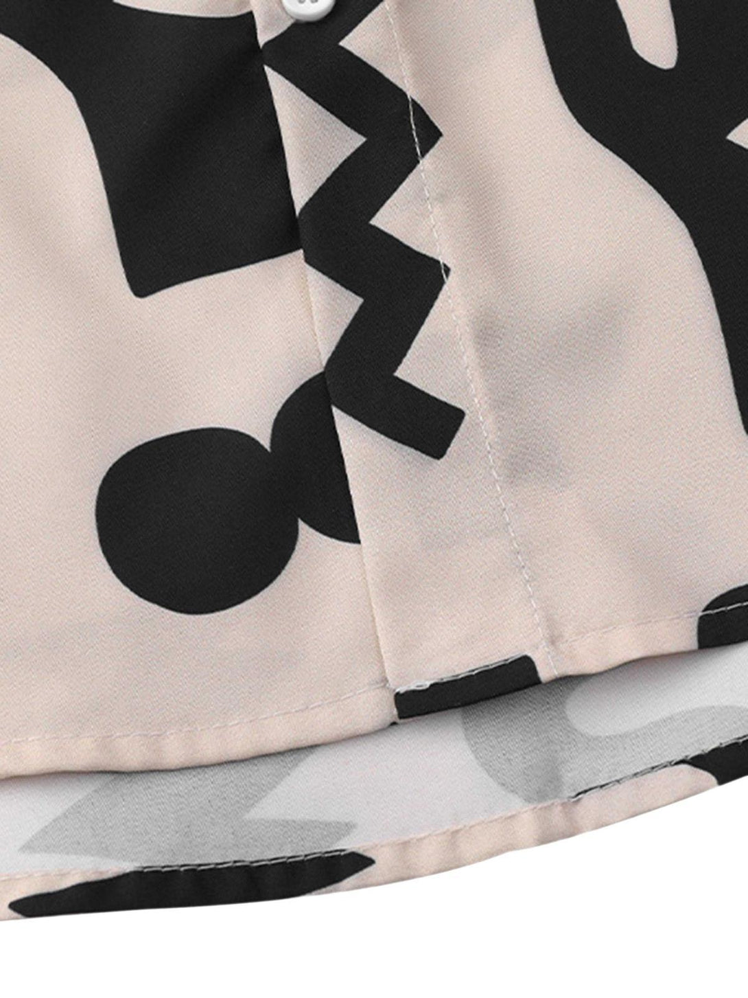 Detailed fabric and stitching of a vintage short sleeve shirt with black abstract patterns by TALISHKO.