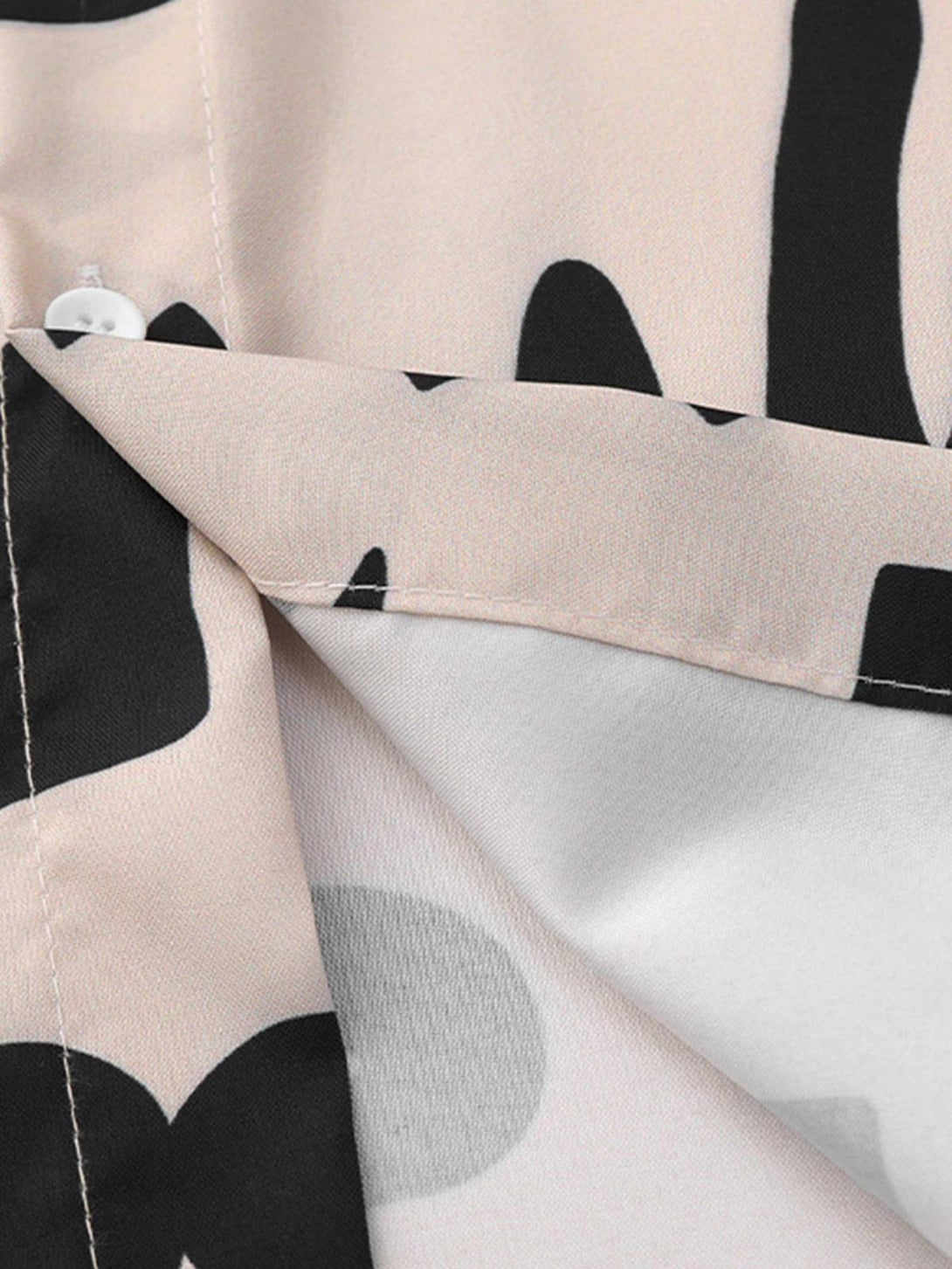 Intricate look at the abstract black and beige pattern on a vintage shirt by TALISHKO.