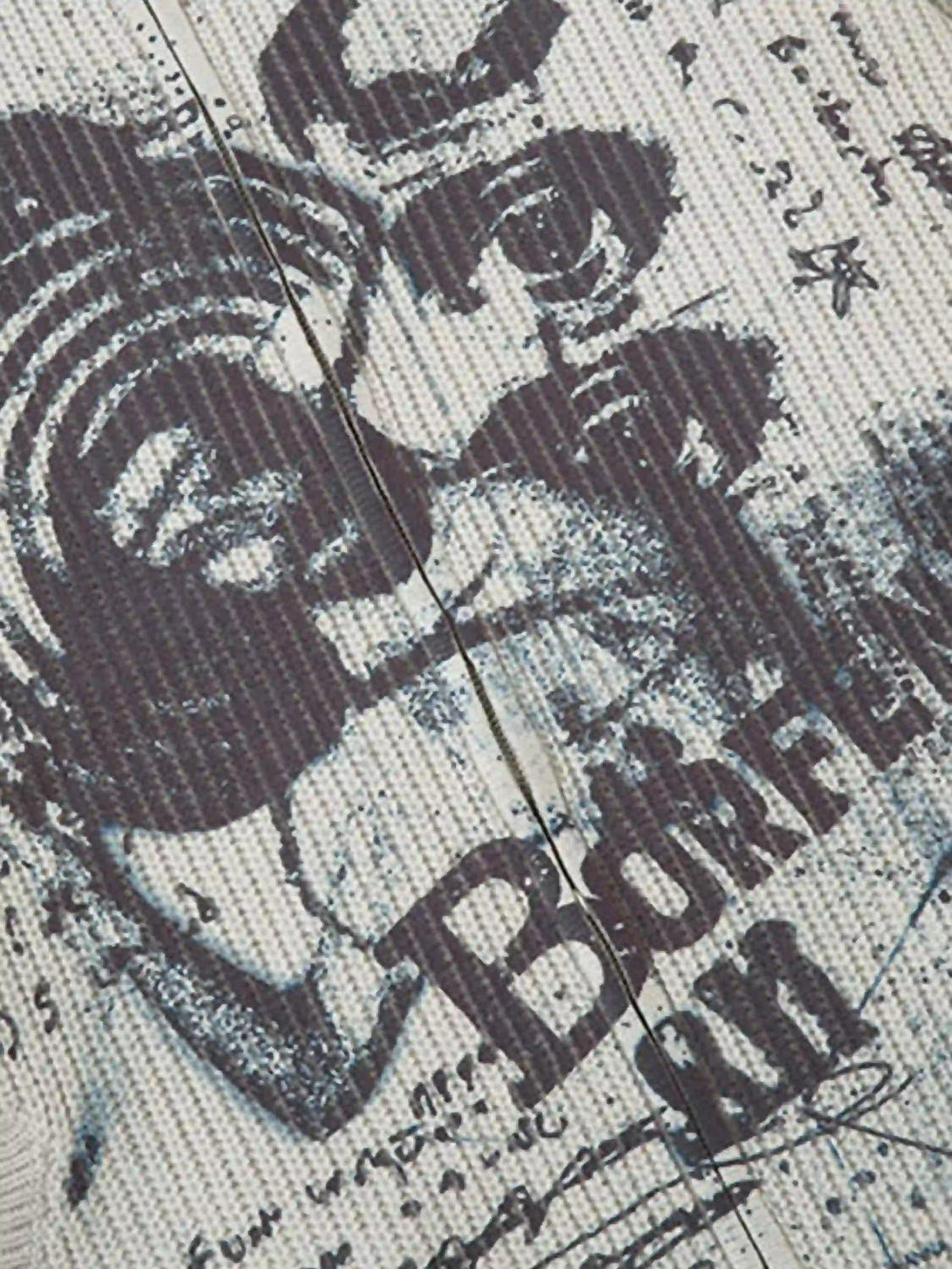 A close-up of TALISHKO's vintage graffiti zip-up cardigan, highlighting artistic prints and texture.