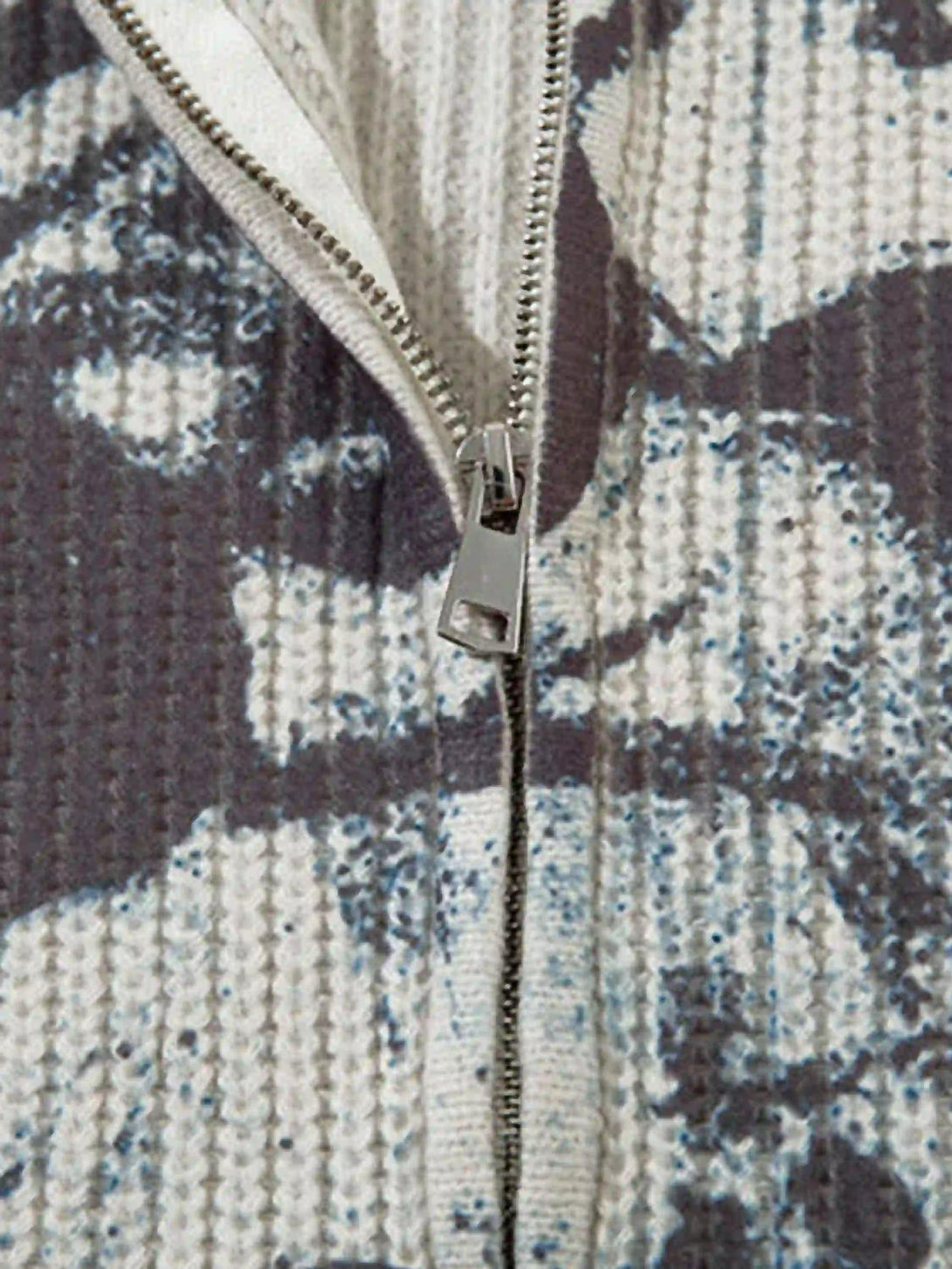 Detailed fabric and zipper design of TALISHKO's vintage graffiti zip-up cardigan.
