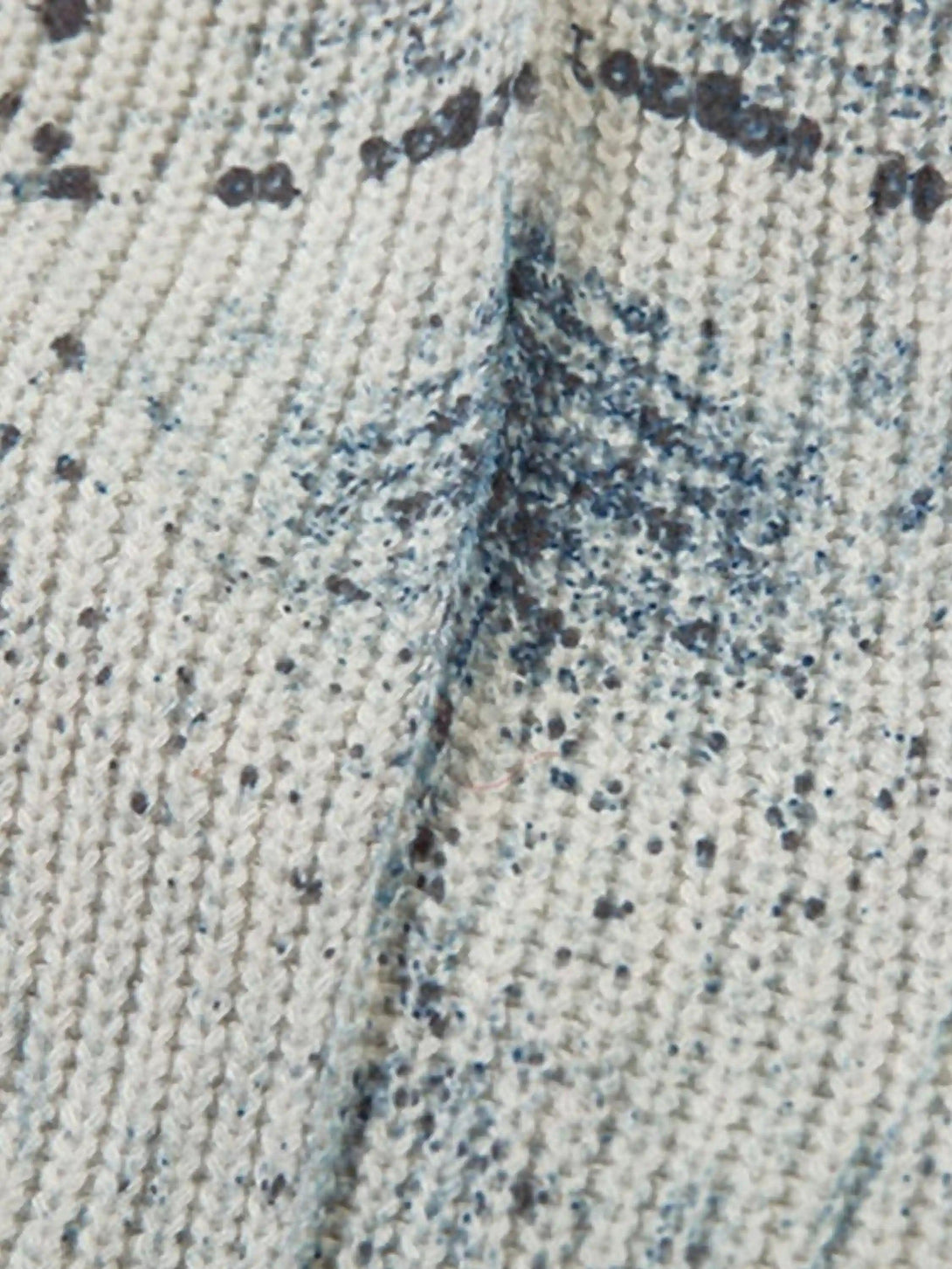 Zoomed-in texture of TALISHKO's vintage graffiti zip-up cardigan, showcasing artistic details.